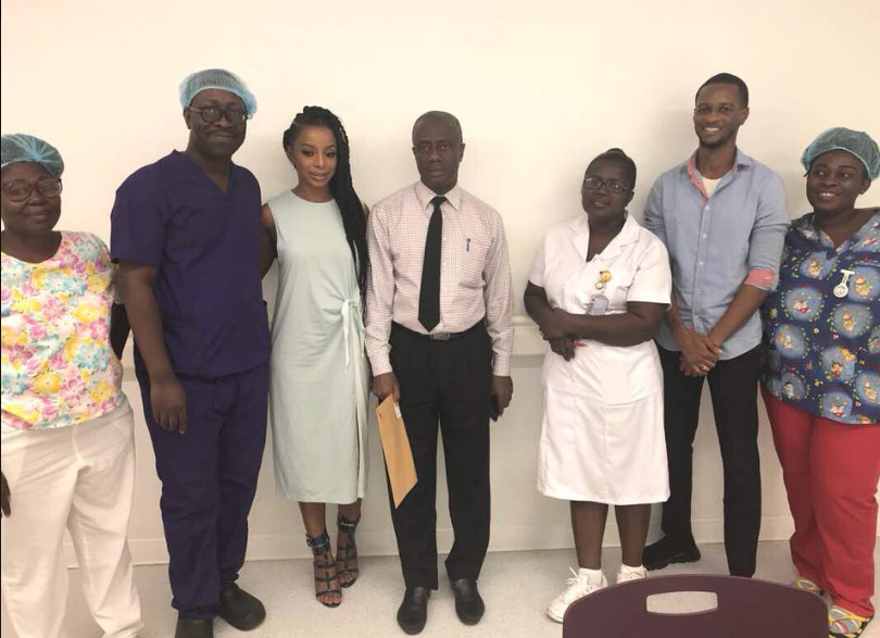 Pictured alongside Dr. Pobee (blue scrubs) and the Ridge Hospital maternity ward staff and James (blue shirt) of CocoRide GH