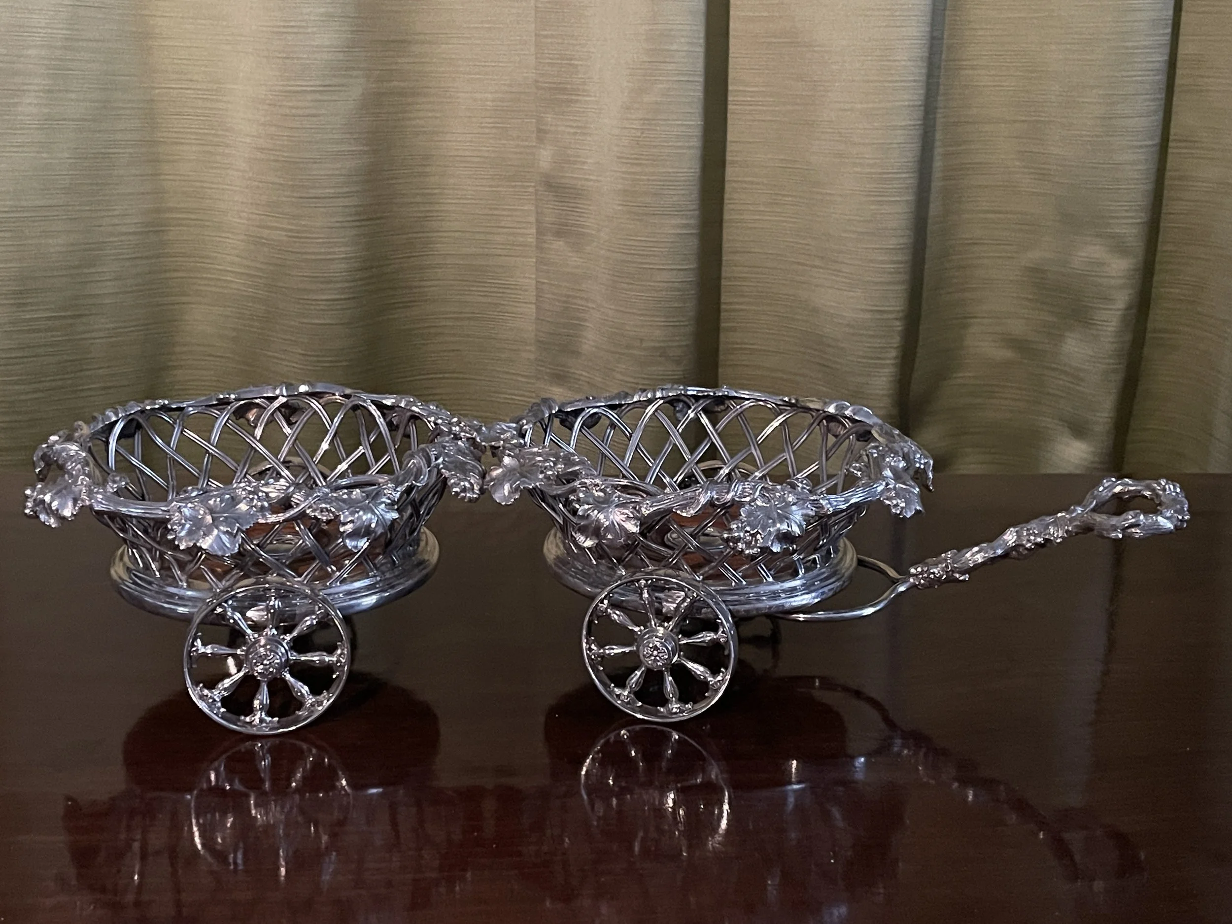 A Victorian silver-plated wine bottle or decanter, coaster trolley, or wagon and pair of matching coasters by Elkington & Co.
