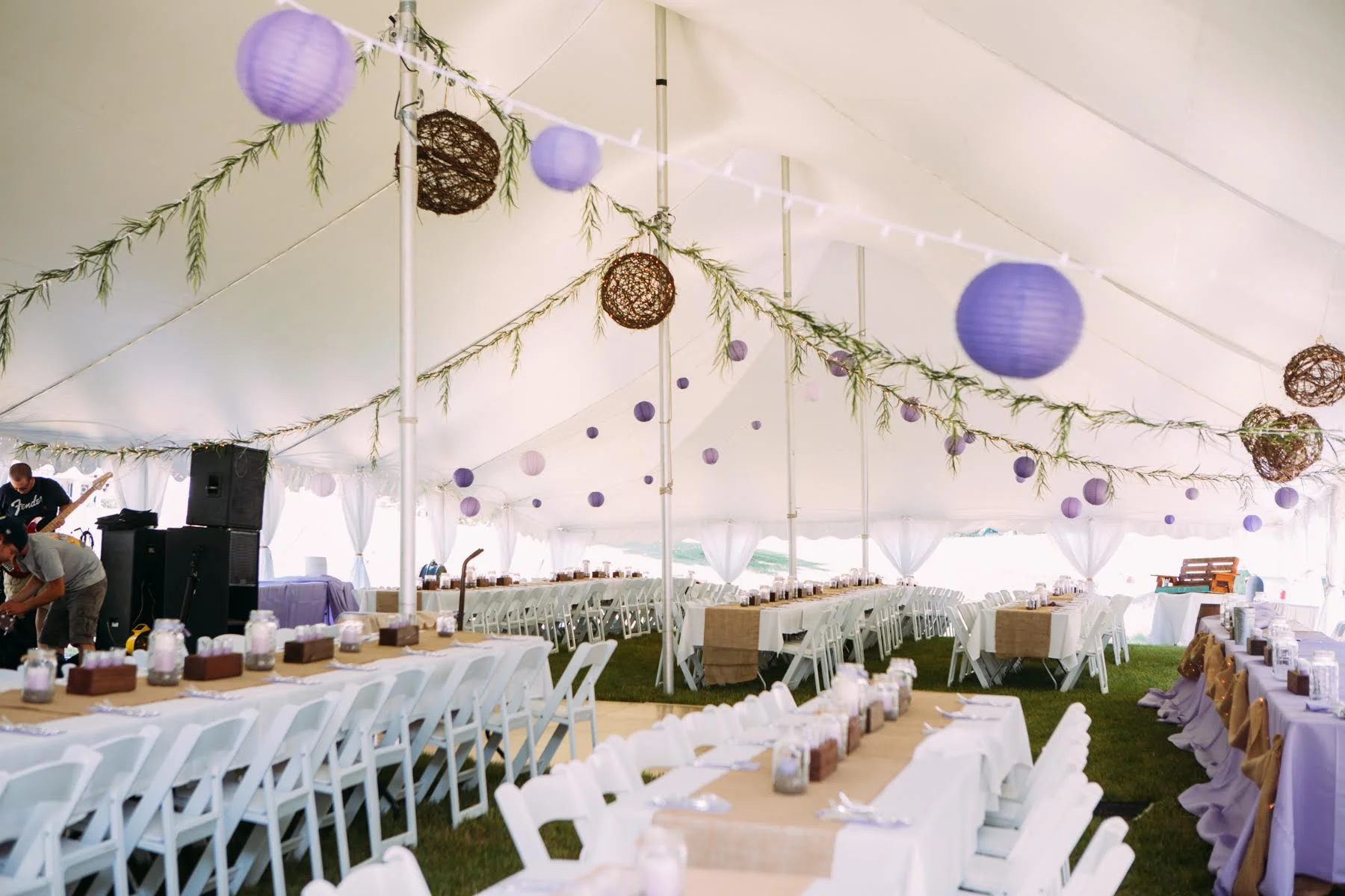 Tented wedding reception with purple and tan chinese lanterns and burlap accents