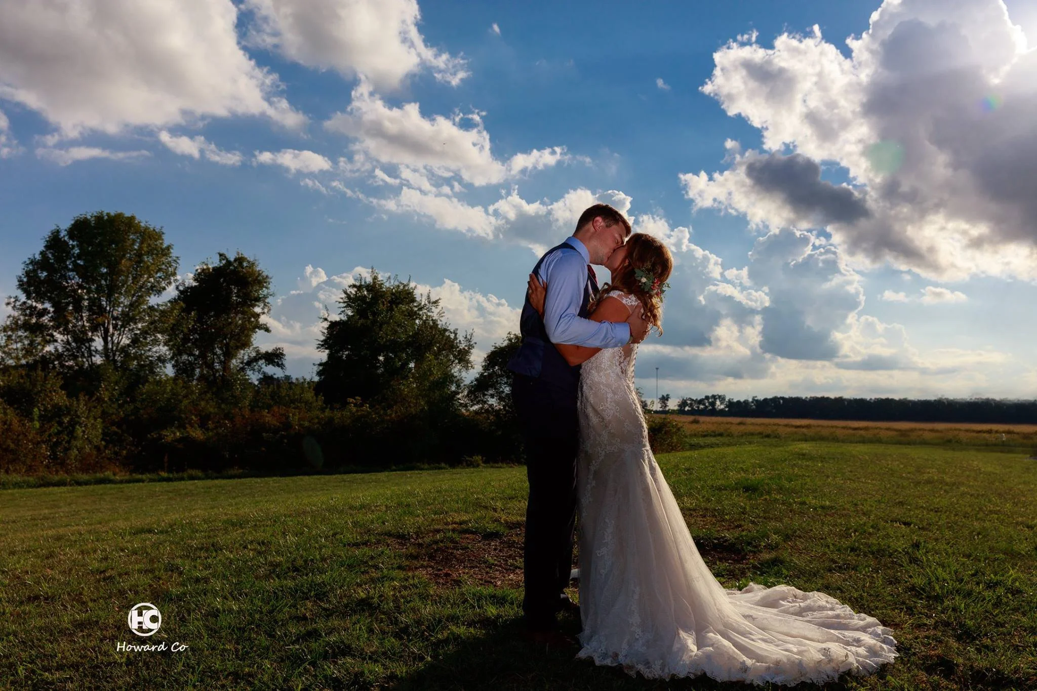 Beautiful sky picture of Bride and Groom kissing at the Legacy Barn in Kokomo, IN