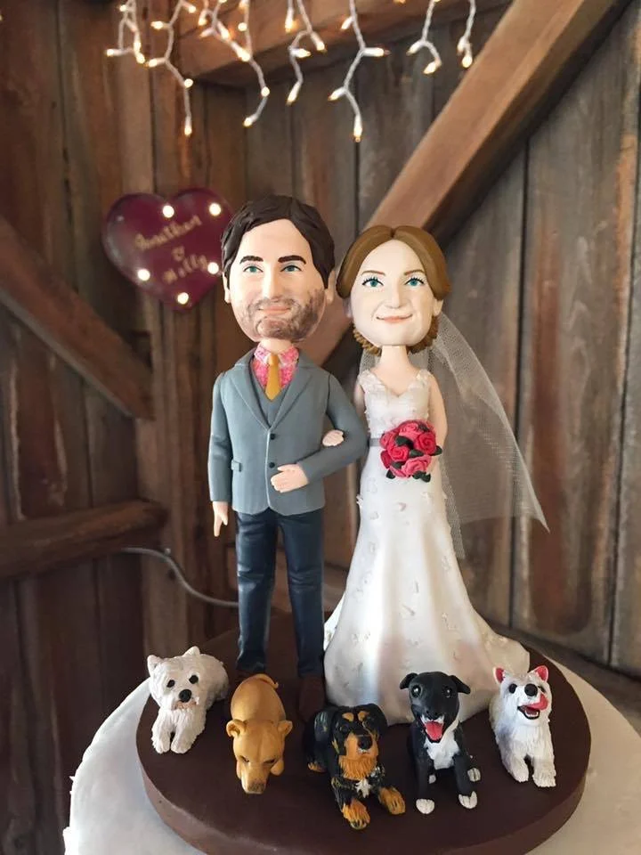 Cake topper customized to the image of the Bride and Groom with their dogs