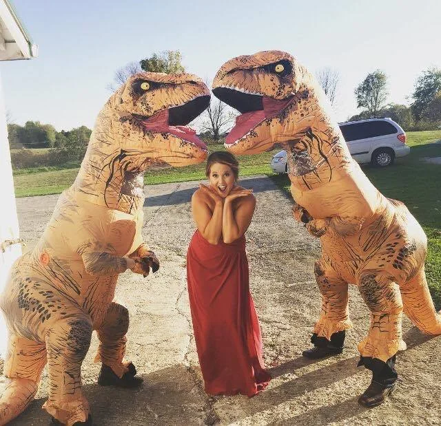 A Bridesmaid with 2 blowup dinosaurs. A Bridesmaid in trouble
