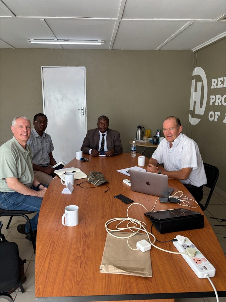 Joe meeting with Peter Cunningham, Bishop Patson Netha, and Pastor Moss Tshuma