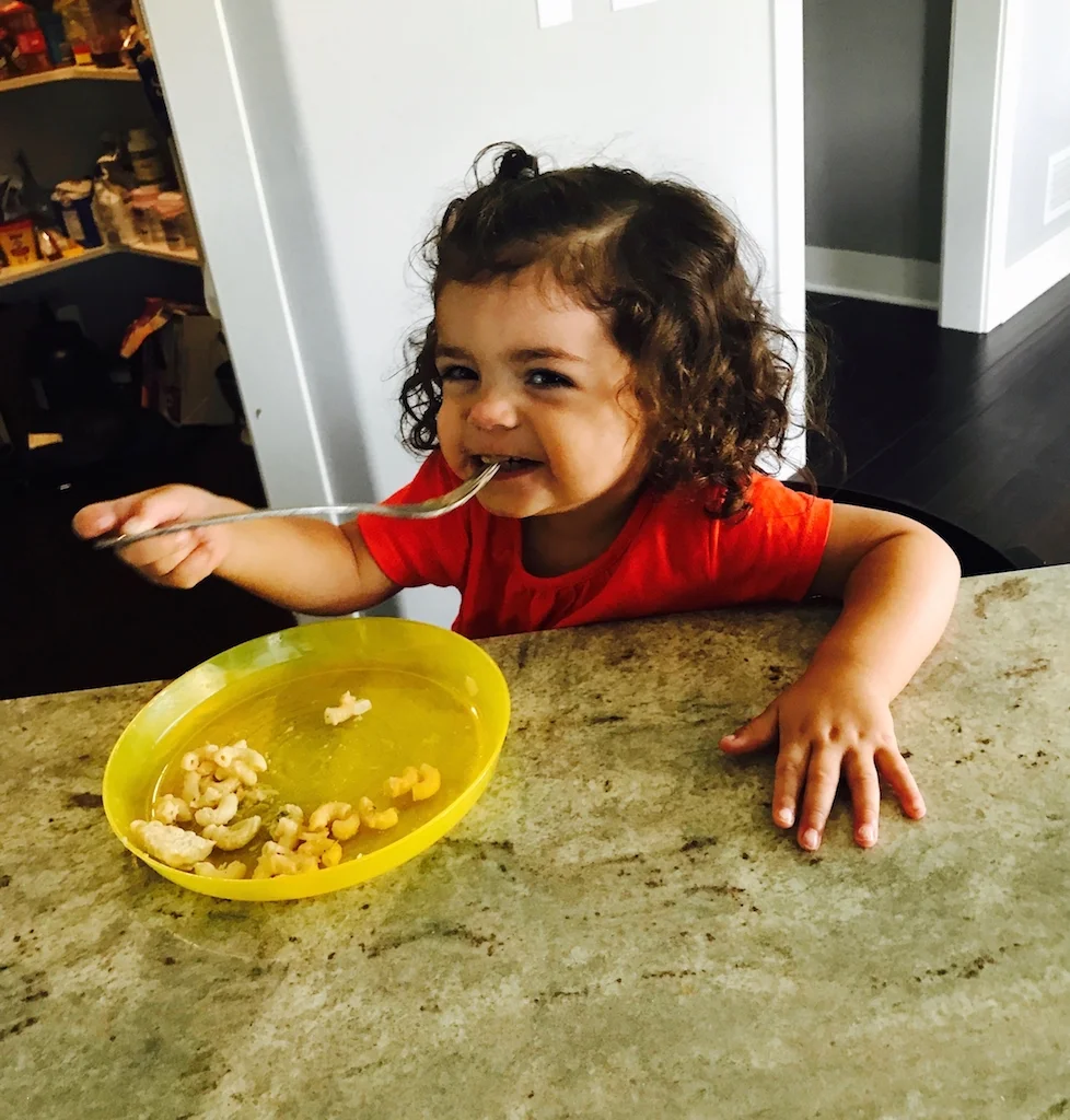 llittle girl eating mac and cheese smaller (on website).jpg