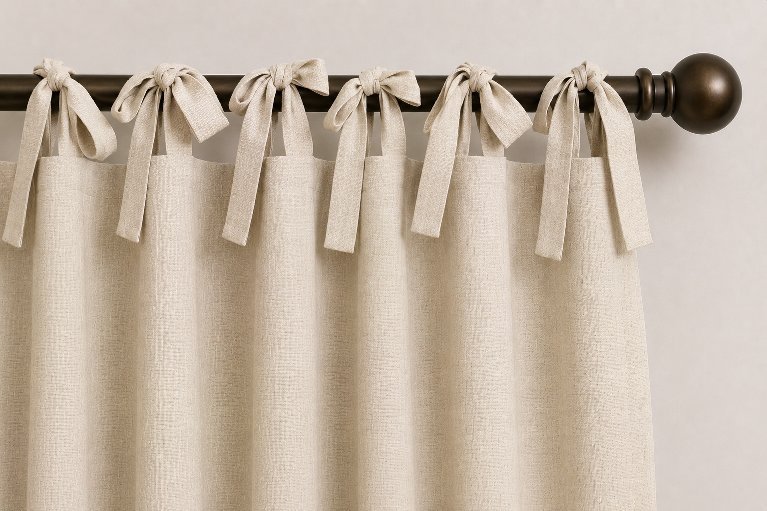 Close-up AI rendering of a cream tie top drapery header with fabric ties knotted around a dark bronze decorative drapery rod, showing the casual and decorative appearance created by the tied fabric loops.