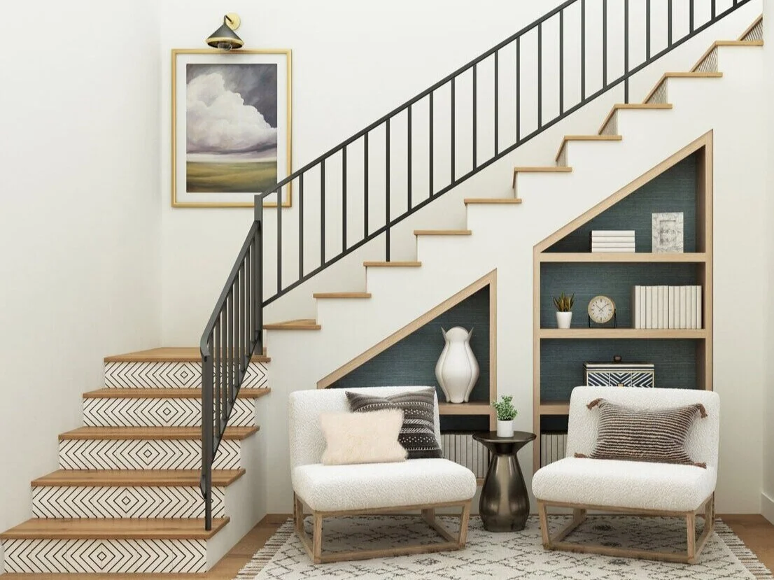 Modern organic staircase design with natural wood steps, black railing, and built-in shelving with seating beneath the stairs by interior designer Joshua Jones.