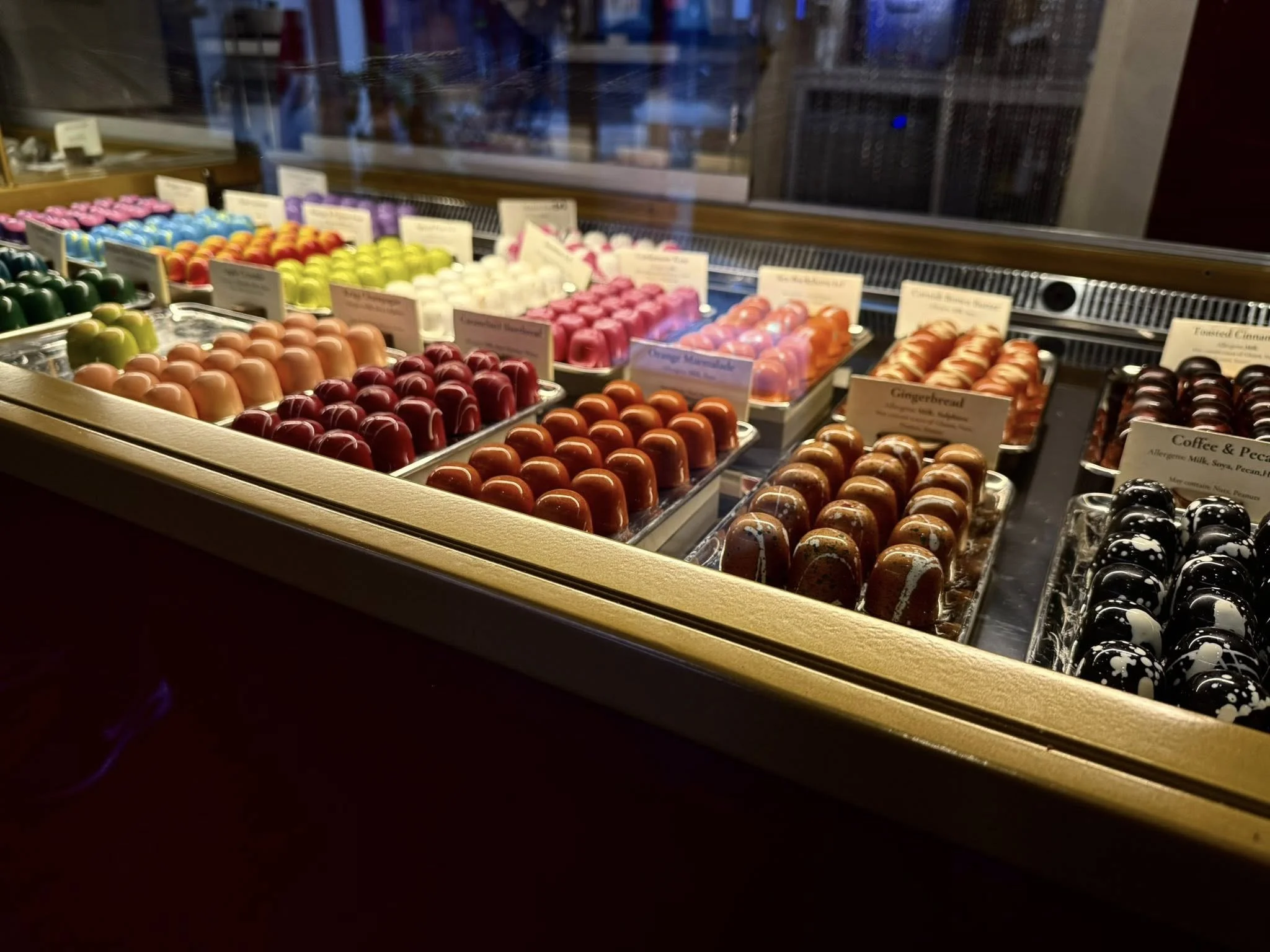 Display of colorful handcrafted chocolate truffles at Adam Handling Chocolate Shop in London