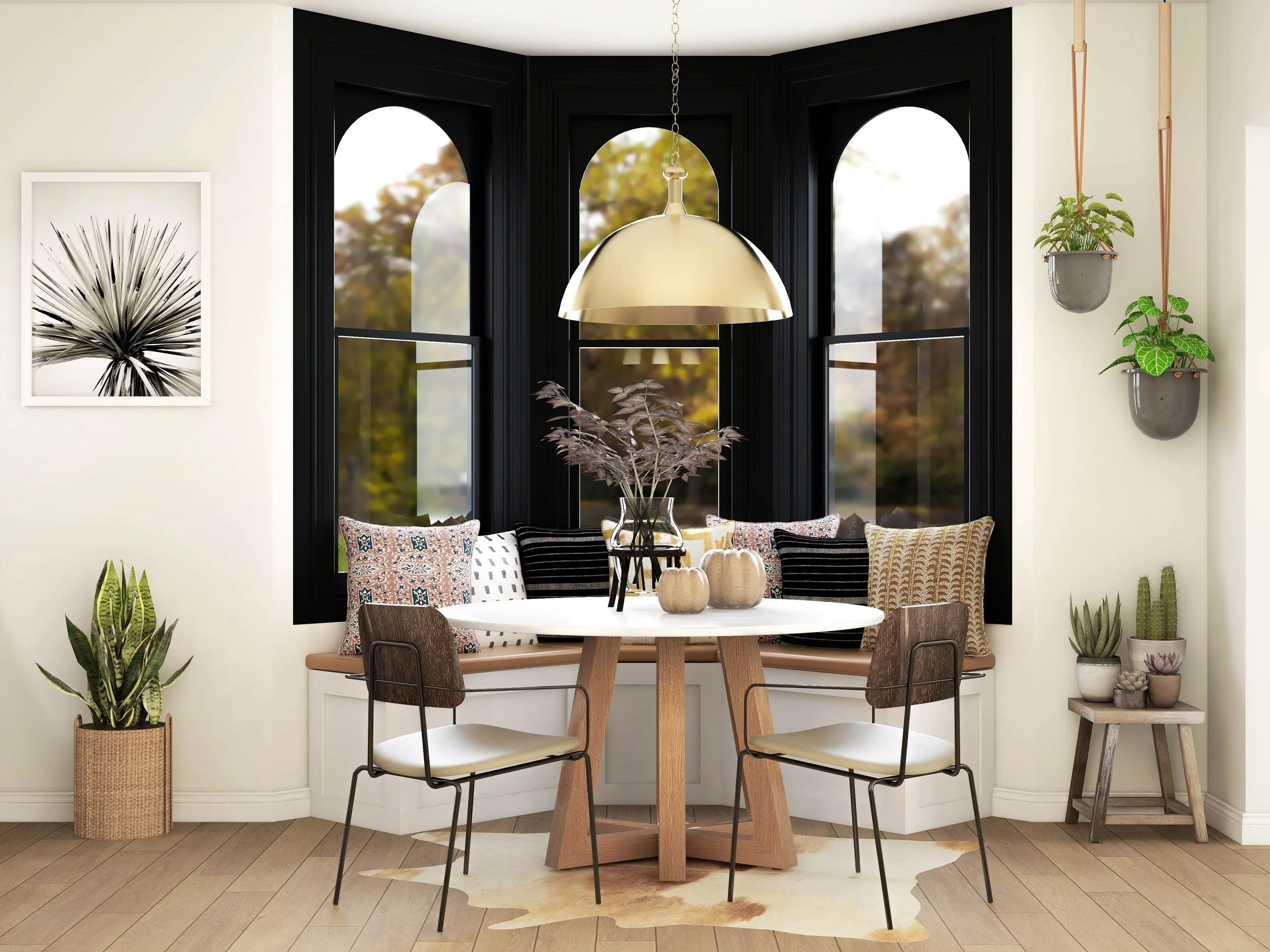 California casual dining nook with a white built-in banquette, round wood dining table, and black-painted trim around arched bay windows, designed by virtual interior designer Joshua Jones of JJones Design Co.