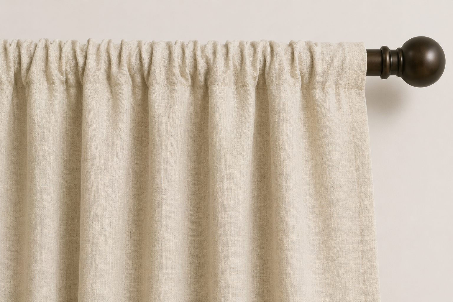 Close-up AI rendering of a cream rod pocket drapery header gathered along a dark bronze decorative rod, showing the sewn fabric pocket with the rod partially concealed inside the panel.