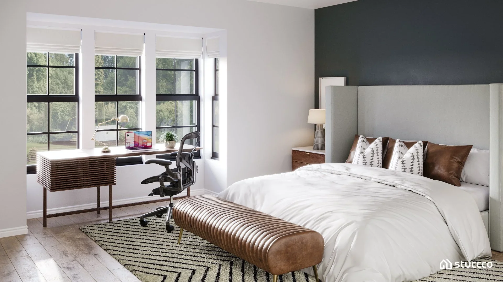 modern masculine bedroom with workspace desk by window and neutral bedding designed by Joshua Jones