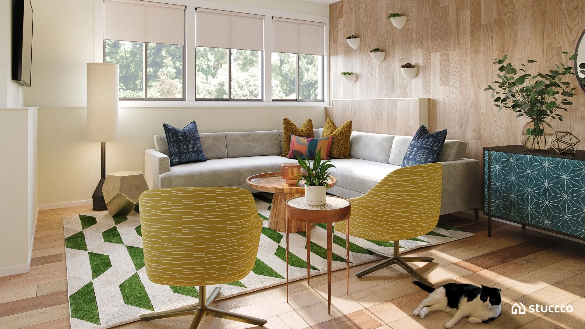 Mid-century modern finished basement living room with a gray sectional, mustard swivel chairs, a green geometric rug, and a wood accent wall, designed by virtual interior designer Joshua Jones of JJones Design Co.