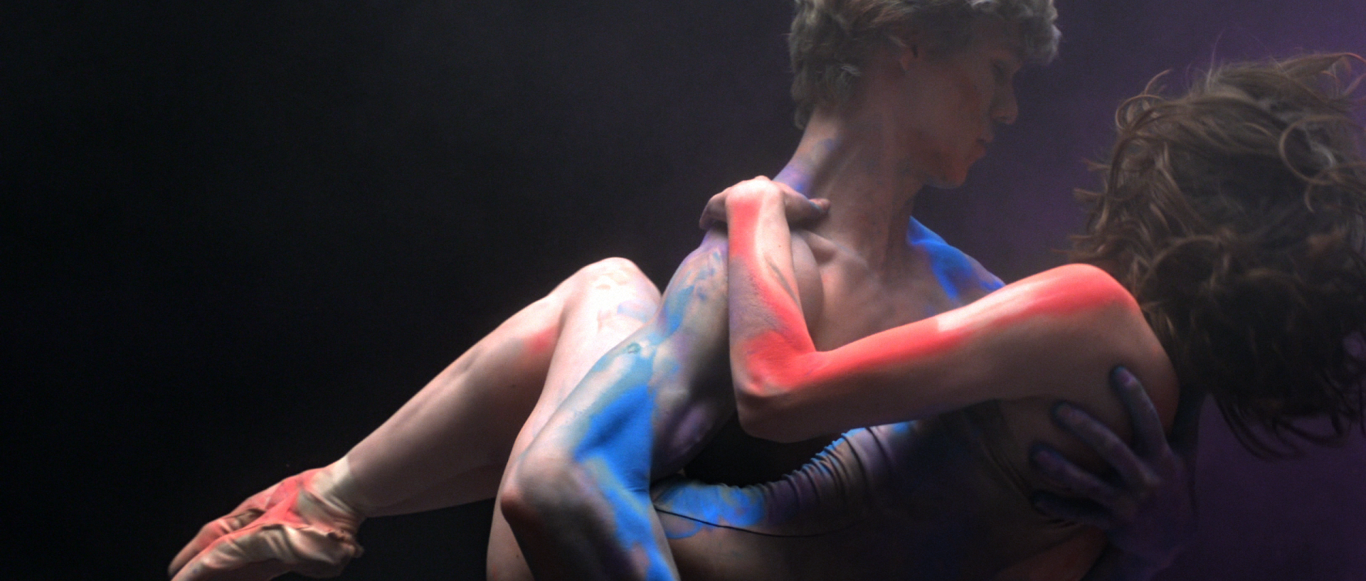 Colorful couple, he cradles her in his arms in BalletMet “Becoming Violet” dance film | Director of Photography, Derek McKane