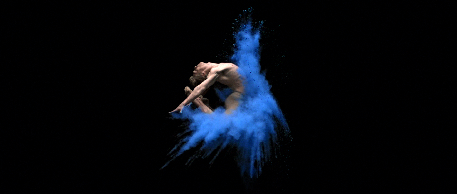 Blue burst of powder, dancer leaps, frozen in air, slow motion in BalletMet “Becoming Violet” dance film | Cinematographer Derek McKane, New York