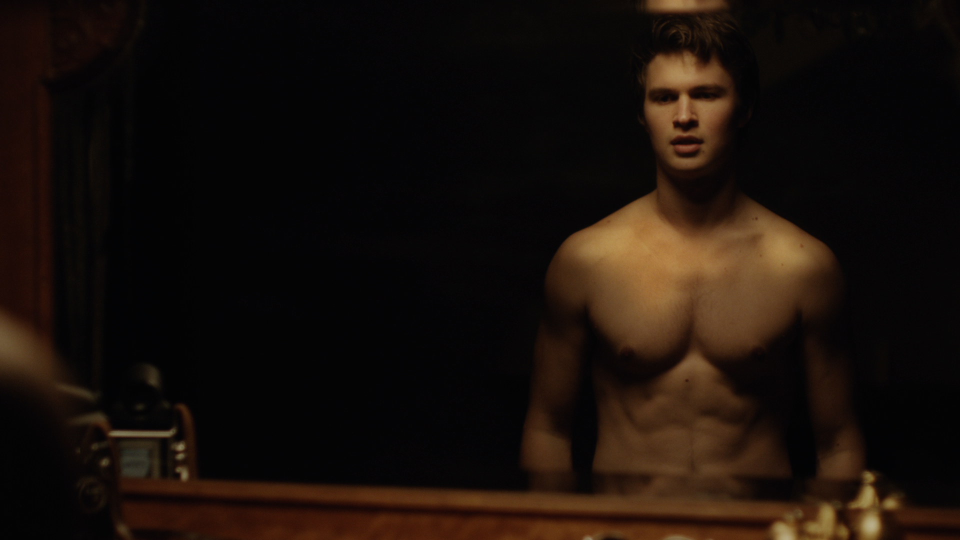 Ansel Elgort shirtless, muscular, reflected in mirror in “Thief” music video