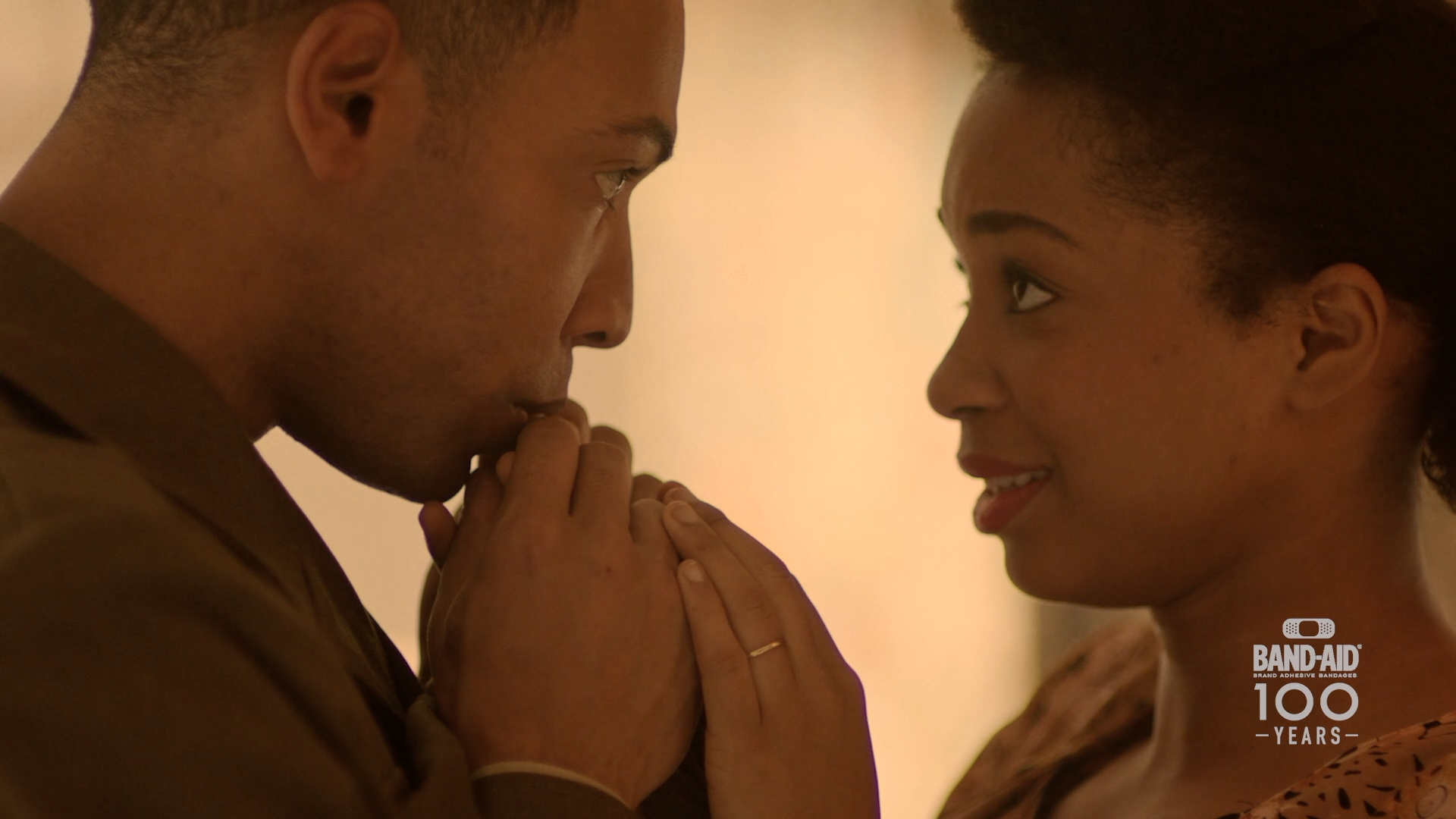 Young soldier kisses wife's hand in Close-up welcome-home frame from Band-Aid 100 Years of Care commercial