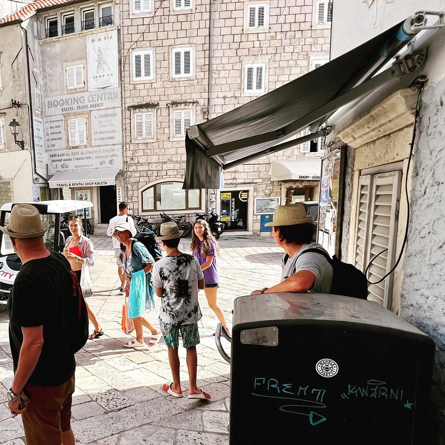 Sticker sighting: Korcula, Croatia. The men in fedoras appear to be protecting the sticker. These men aren't us.