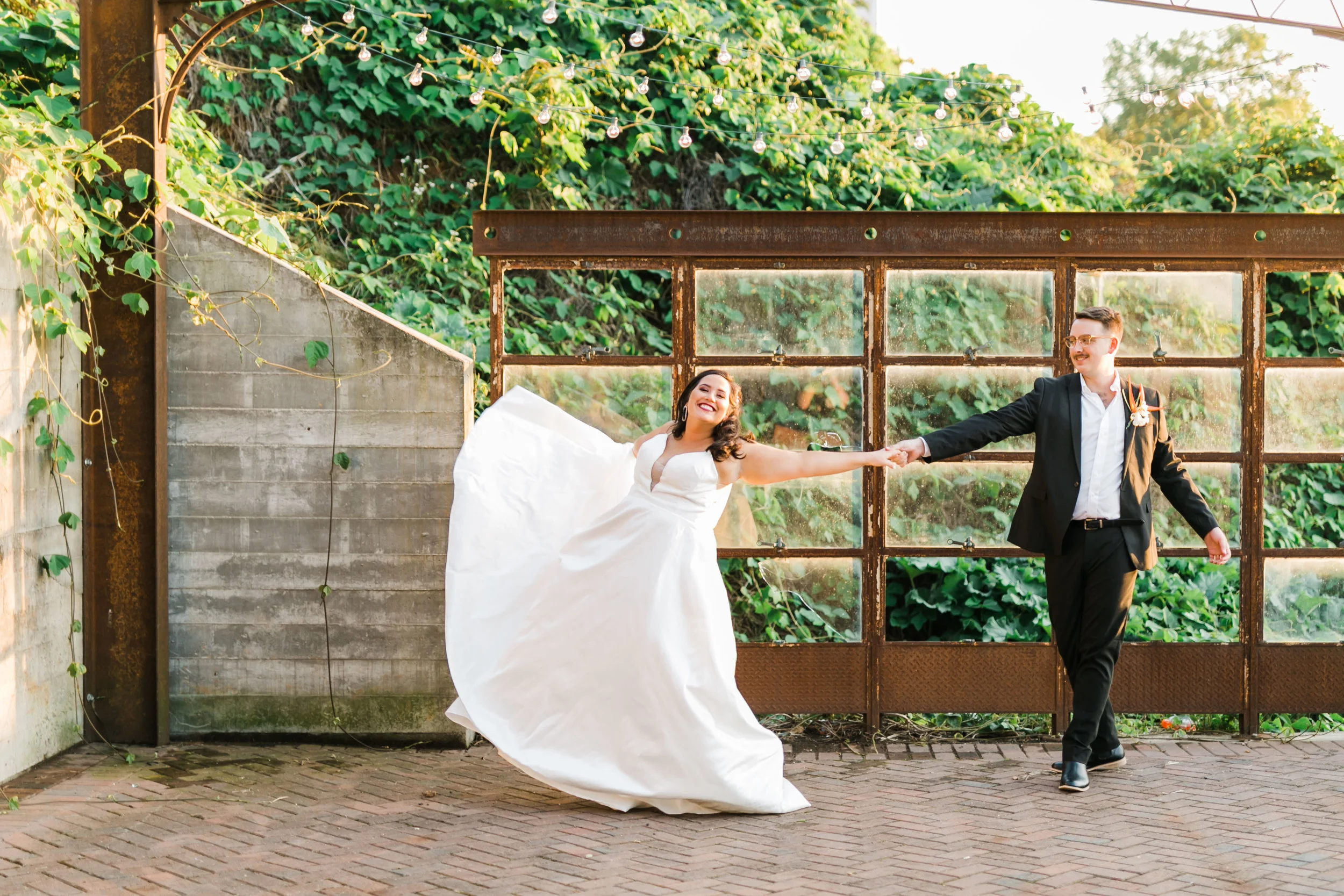 bride and groom twirling on rooftop at the standard patio knoxville summer