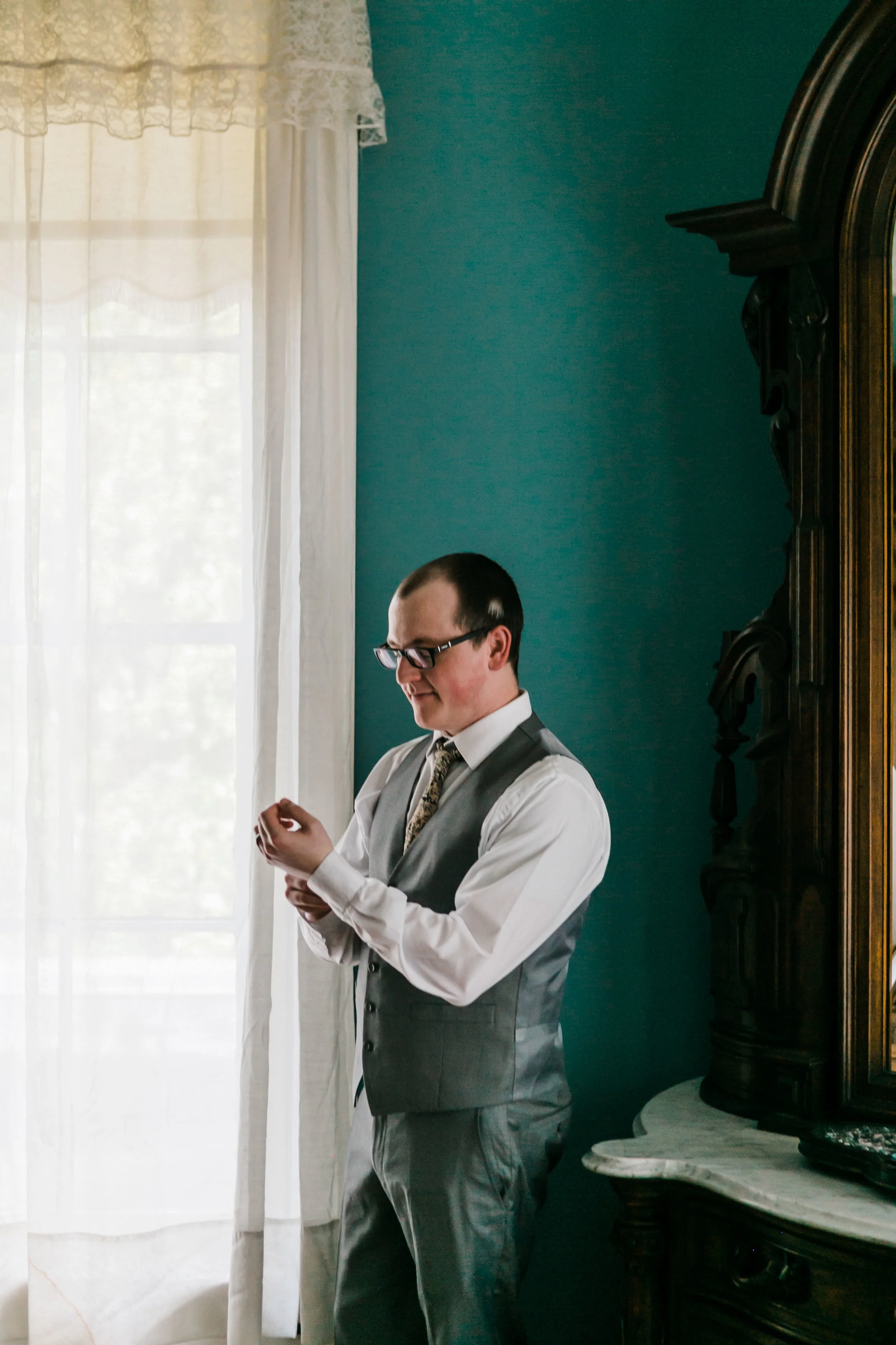 groom in teal room at bleak house