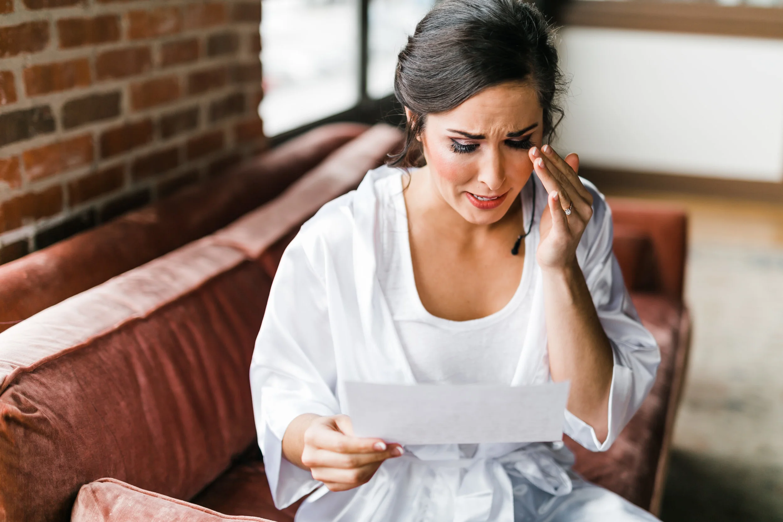 bride reading letter in robe crying in bridal suite at the standard in knoxville tn