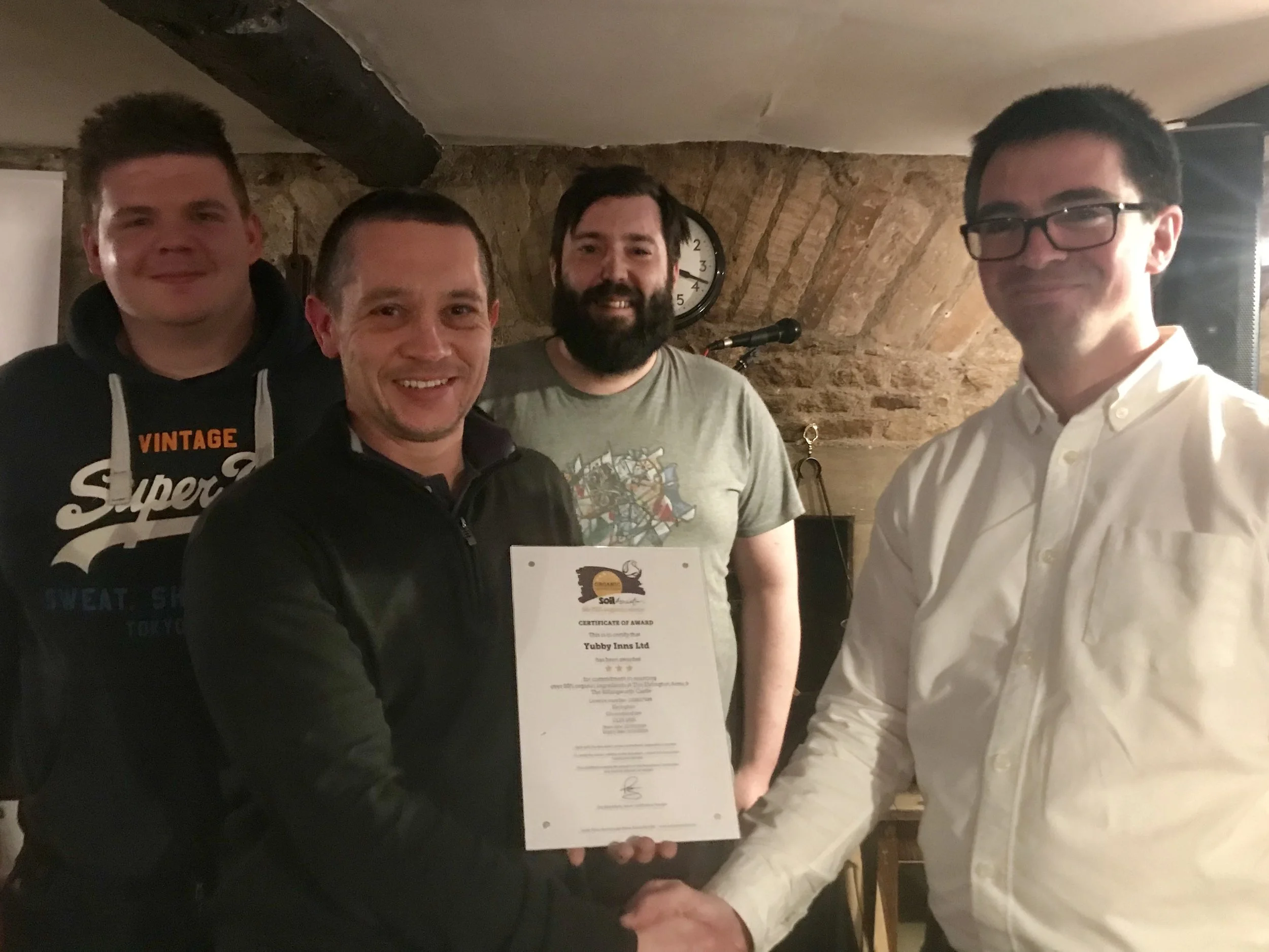 Corey, Darral and ill receiving the award from the Soil Association’s Mark Machin