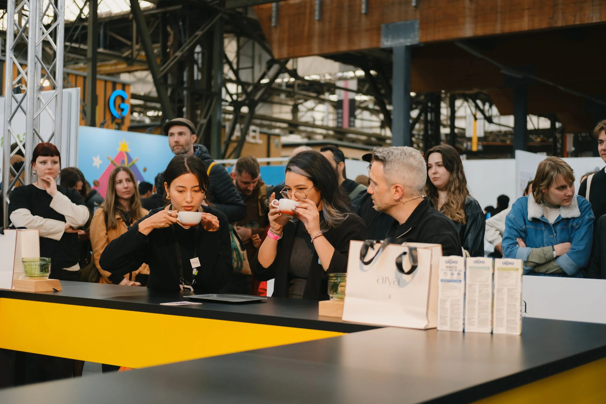 Three people, the judges, tasting the mattcha latte