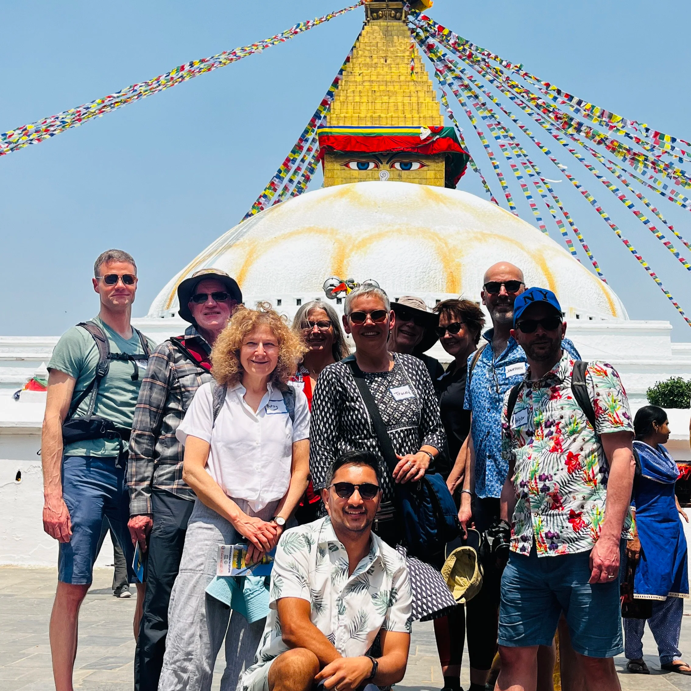 A group of people in front of a Nepalese monument