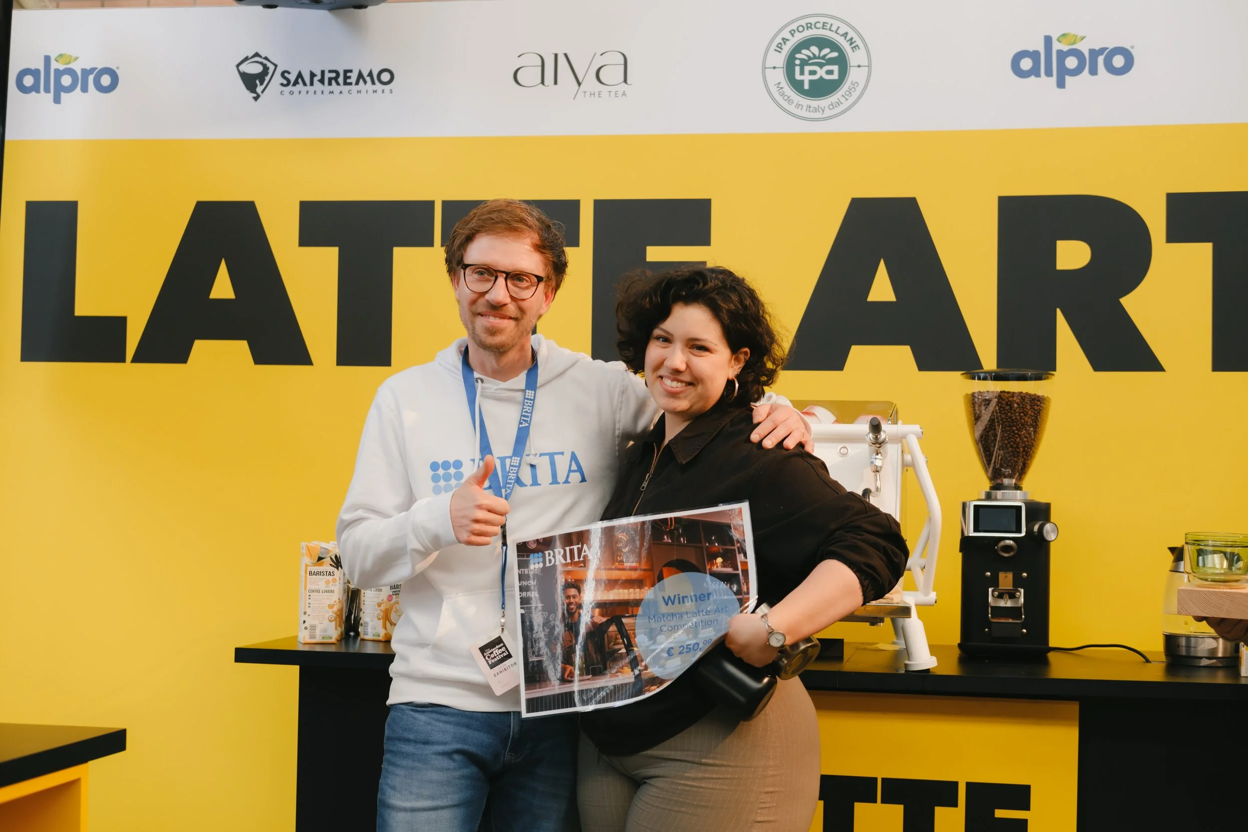 Megan Virginia Brown Suarez with a person from Brita showing her prize