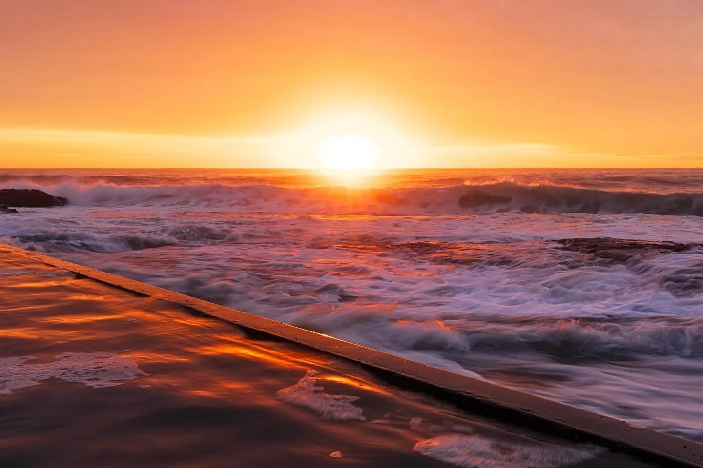 &ldquo;Morning Glow&rdquo;
Sunrise / Kiama, South Coast, NSW, Australia .

An amazing sunrise, viewed down by the Ocean Pool at Kiama.
A big swell flooding the foreground, with occasional waves crashing over the pool wall!