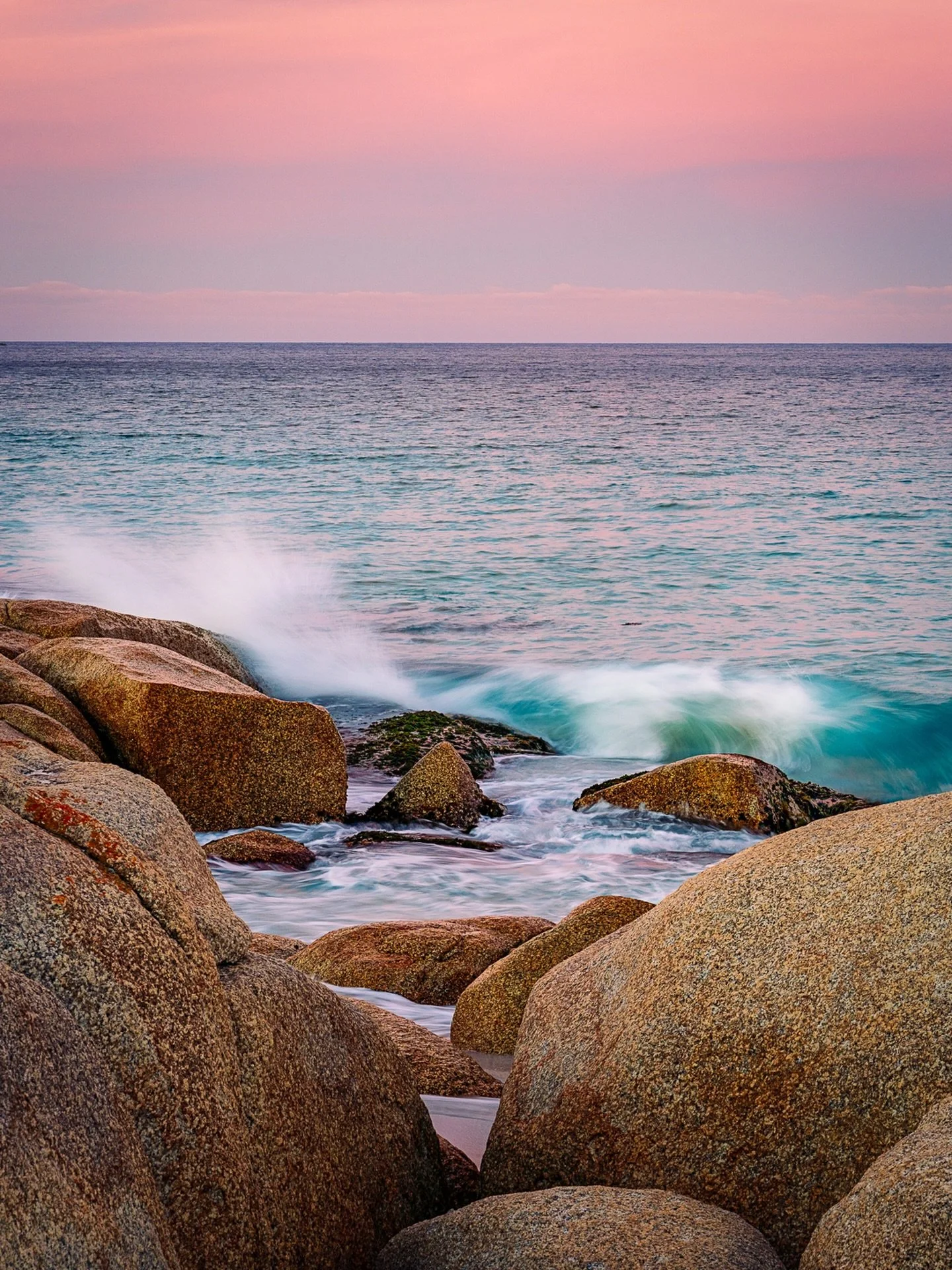 &ldquo;Sunset Over the Bay&rdquo;
Sunset / Bay of Fires, Tasmania, Australia .

A &rdquo;reverse&rdquo; sunset over Binalong Bay.
No reds in the sky, though some lovely pastels and that striking water!!