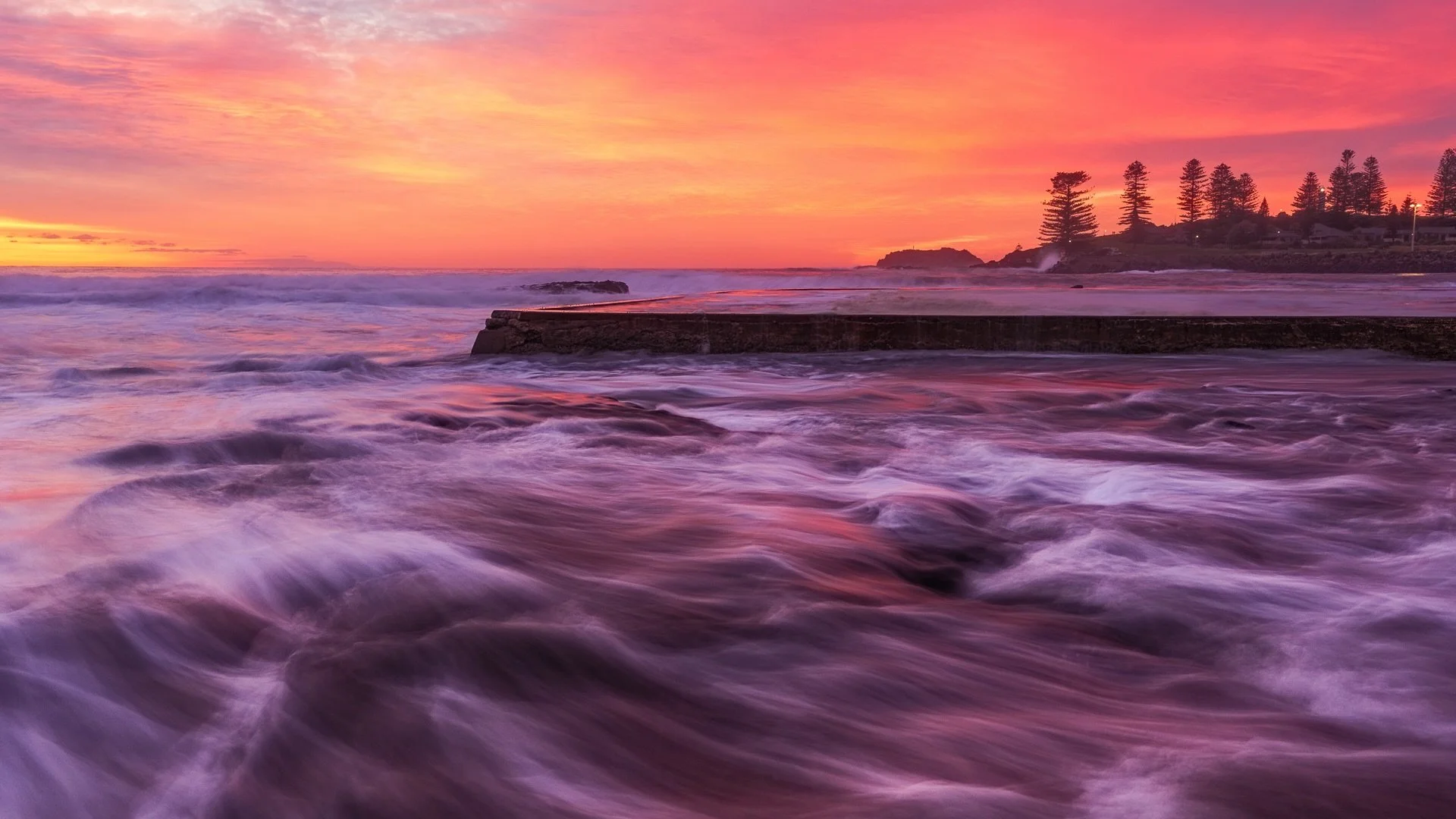 &ldquo;Down by the Pool&rdquo;
Sunrise / Kiama Ocean Pool, NSW, Australia .

High tide, luckily a smallish swell, but every 10 minutes or so the surge would come in wash over my feet!
Lovely to watch the water interact with these sunrise colours!