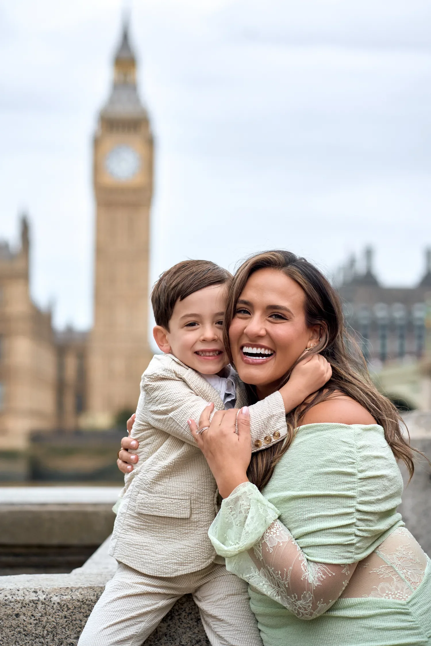 Mother hugging toddler son on Westminster Bridge with Big Ben behind