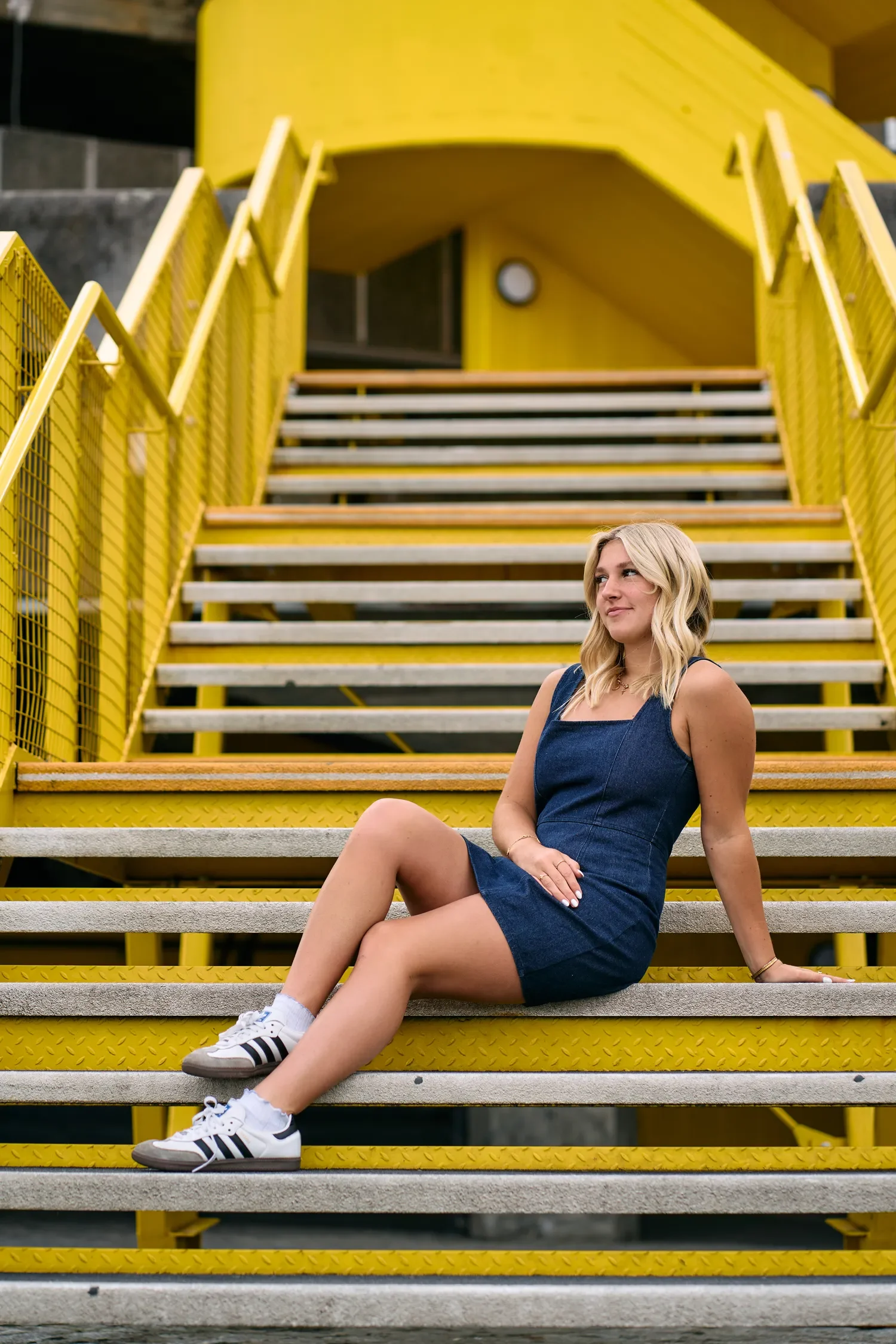 Close-up of school senior portrait outfit and trainers on the South Bank yellow stairs, sitting