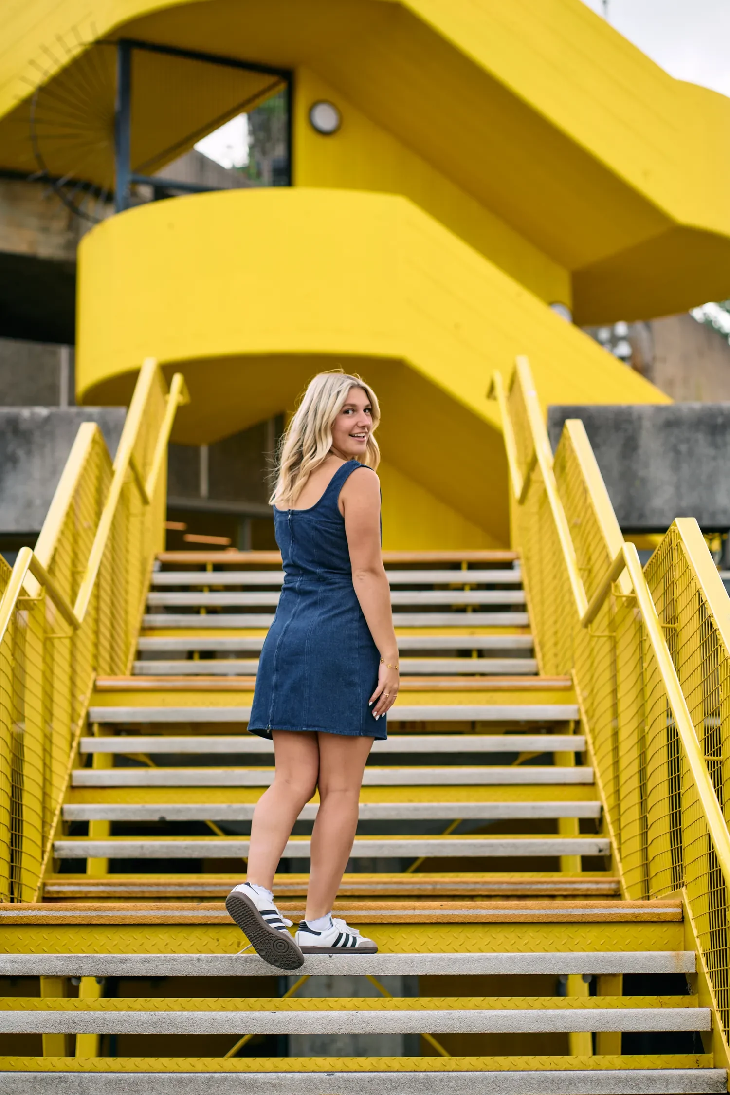 Close-up of school senior portrait outfit and trainers on the South Bank yellow stairs, walking
