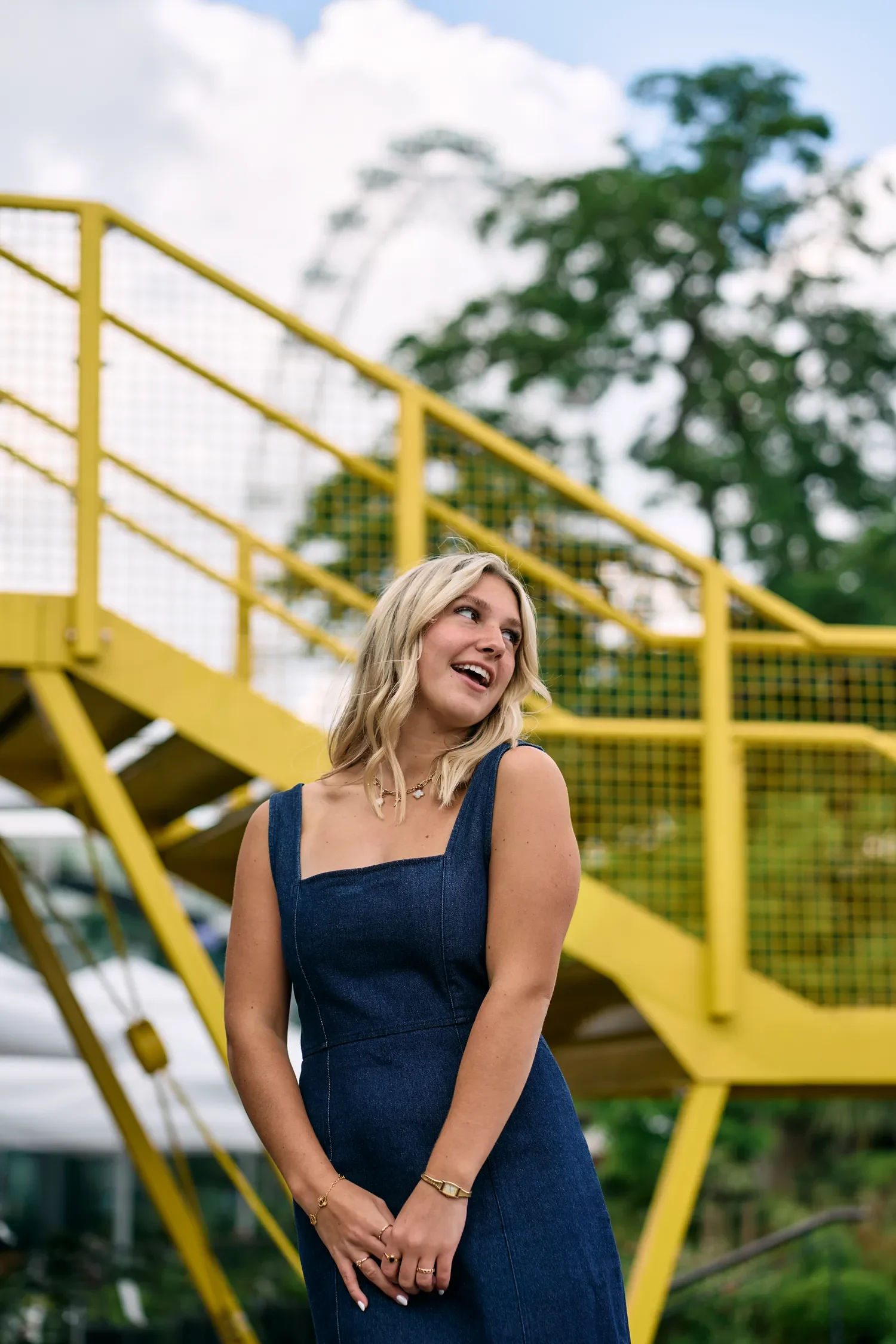 School senior laughing on the yellow stairs at South Bank, London