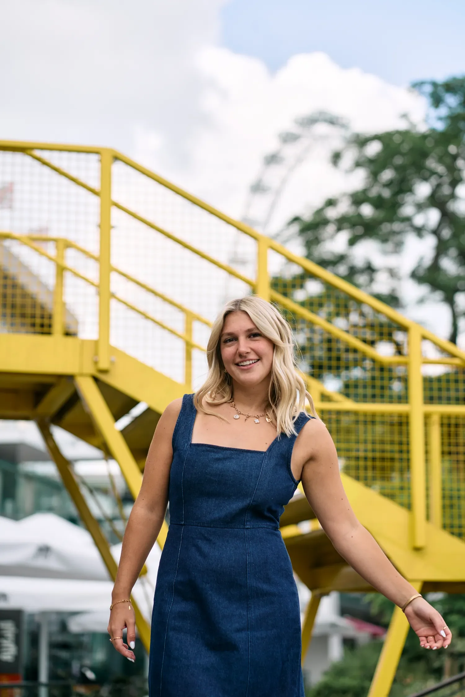 School senior on the South Bank yellow stairs, looking back over her shoulder