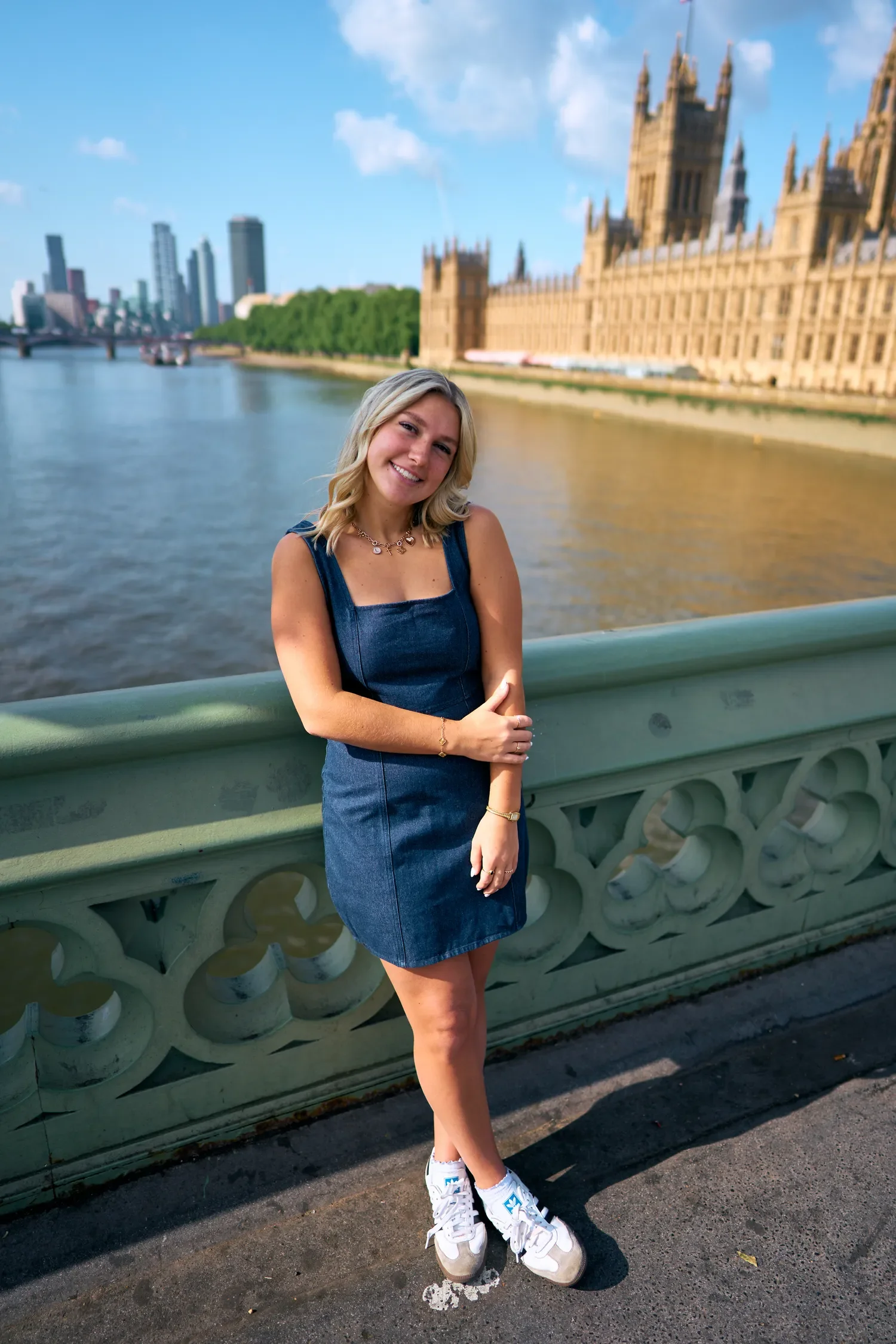 School senior portrait leaning on the railing of Westminster Bridge at golden hour
