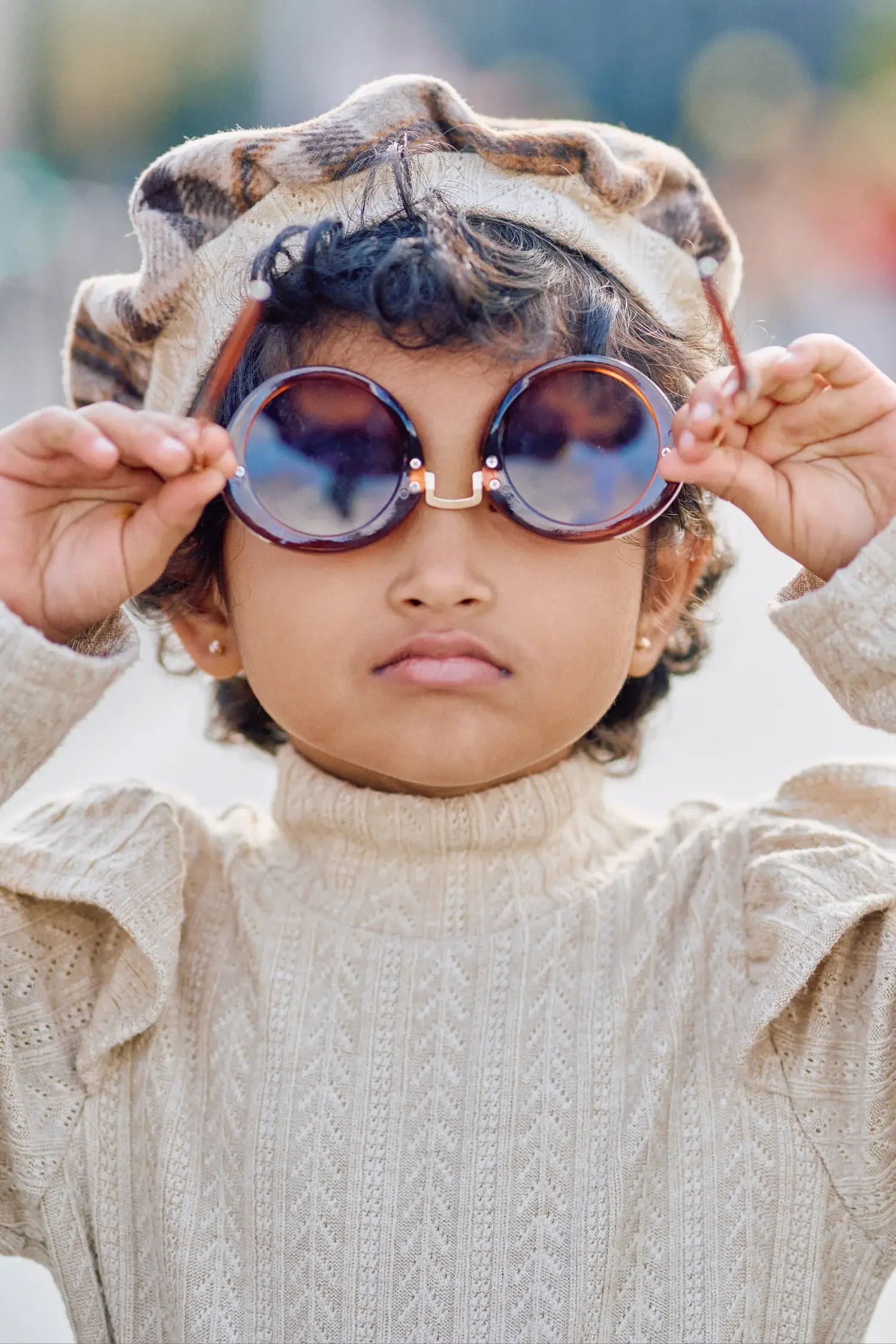 Toddler girl trying on sunglasses during a Westminster Bridge photoshoot