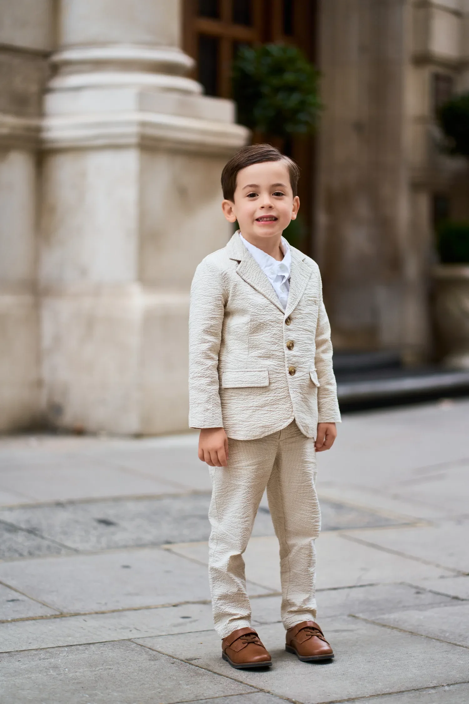 Toddler boy in a beige tweed suit for a London family photoshoot