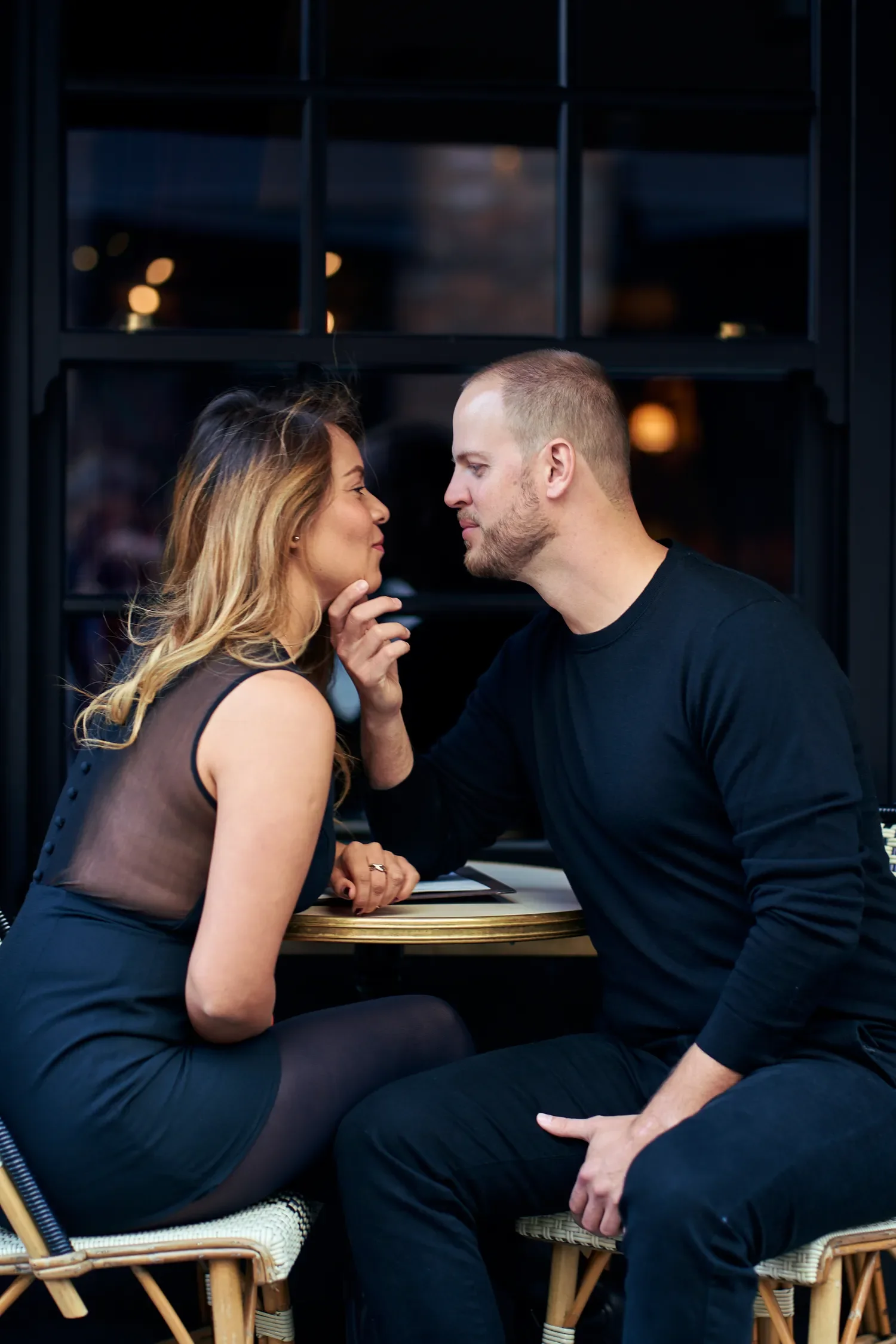 Couple sharing intimate moment at outdoor café table, Covent Garden London couple photography