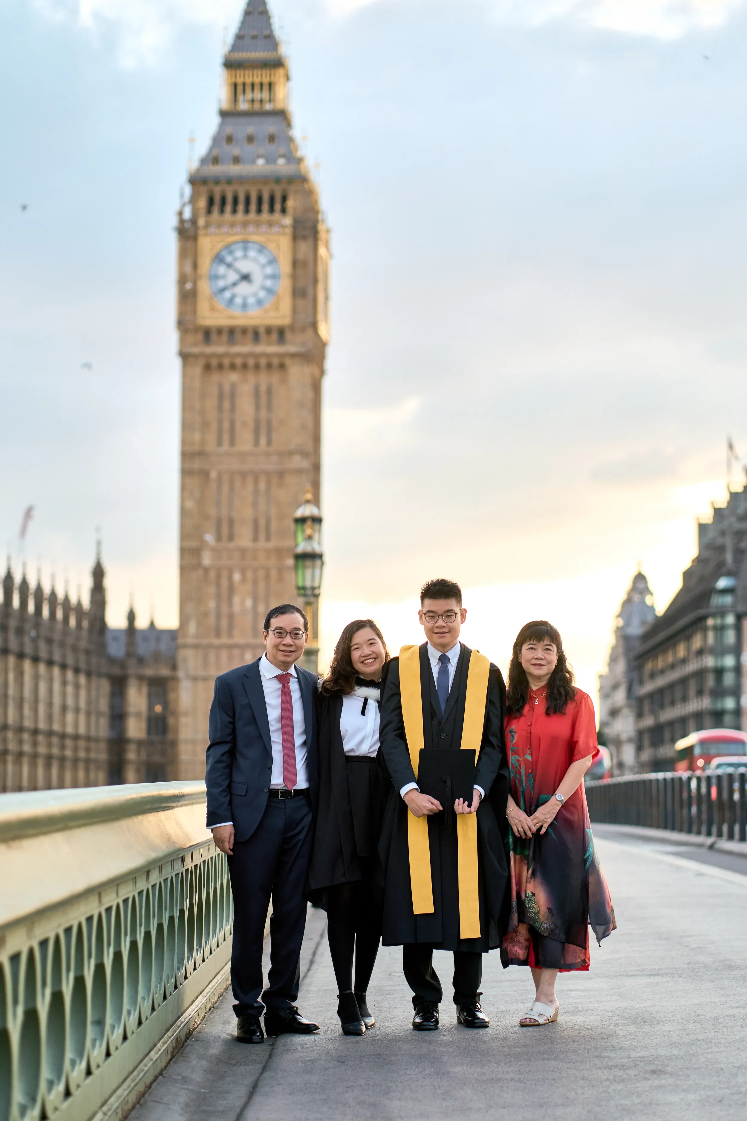 Family graduation photoshoot on Westminster Bridge at golden hour with Big Ben in the background, London