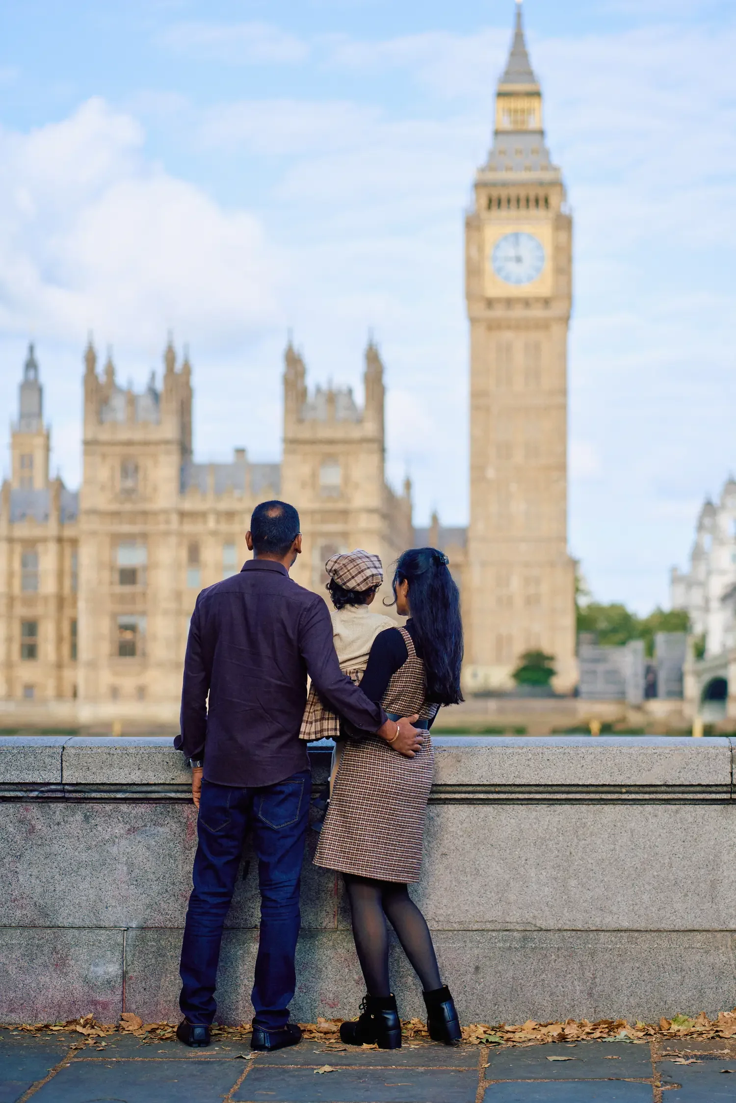 Family looking out over the Thames from the embankment, London photoshoot