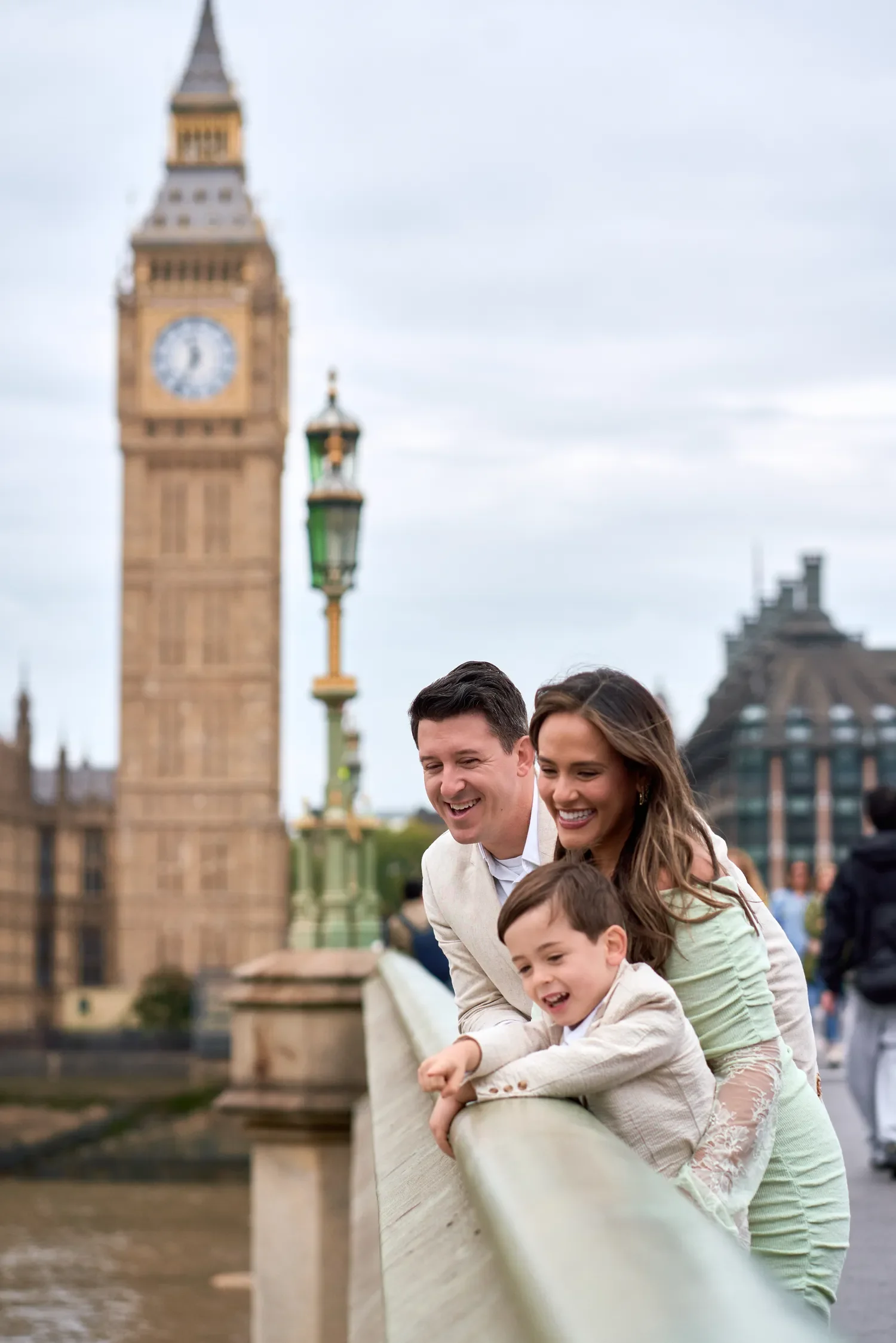 Family looking out over the River Thames from Westminster Bridge, Big Ben behind them