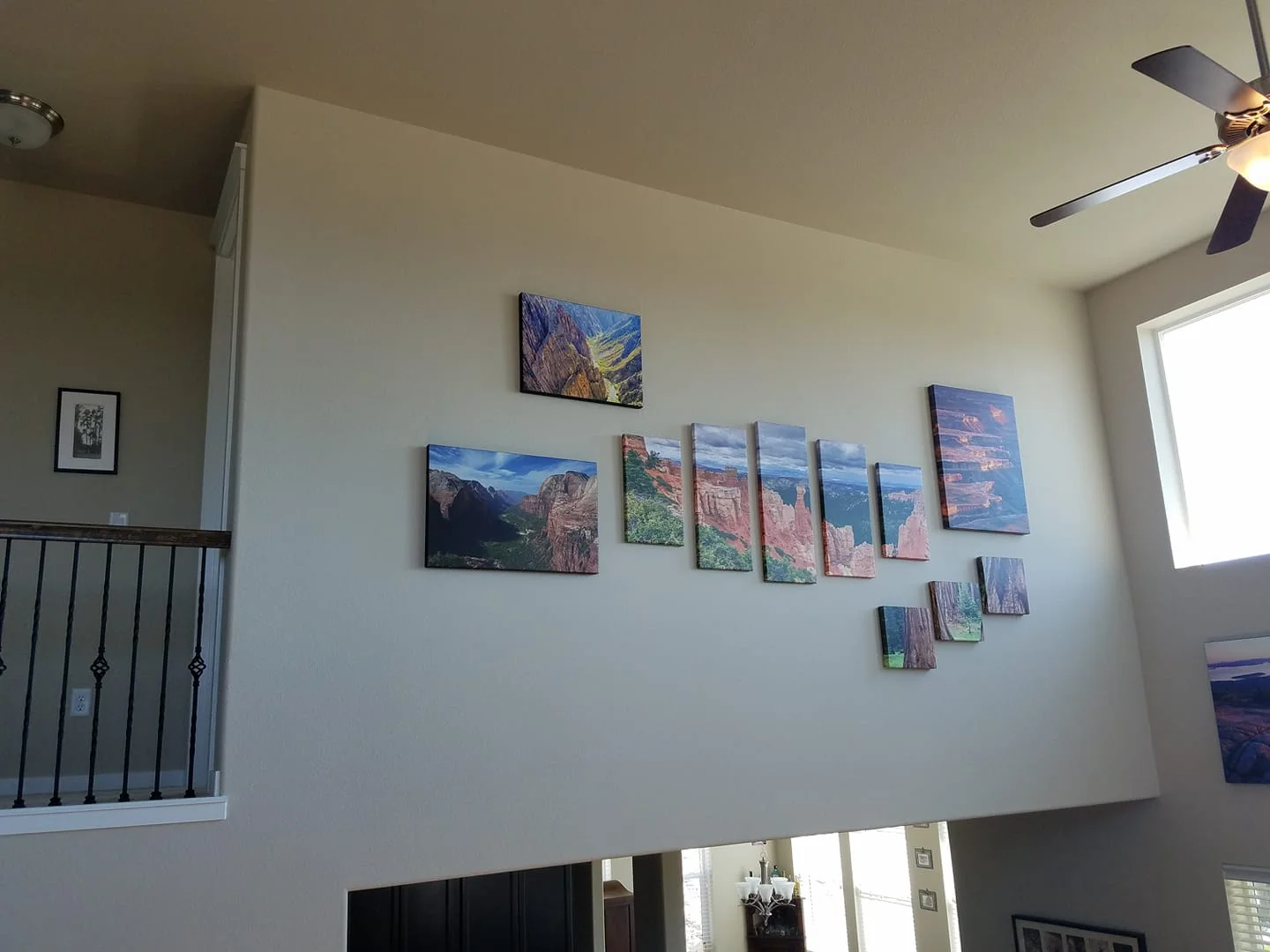 THIS 2 STORY WALL WAS A LITTLE TRICKY TO FIGURE OUT LAYOUT AND WHAT WOULD LOOK GOOD. WE PHOTOSHOPPED THE ARTWORK ONTO THE WALL BEFOREHAND SO WE COULD WORK OFF OF A CONCEPT AND GENERAL IDEA FOR PLACEMENT. IT WORKED GREAT ON ALL THESE HIGH WALLS!