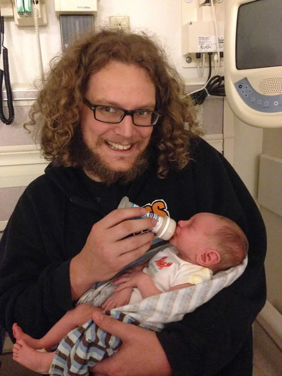 Ray feeding Little M his very first bottle while we waited in the ER. What you don't see is my behind the camera bawling my eyes out in guilt.