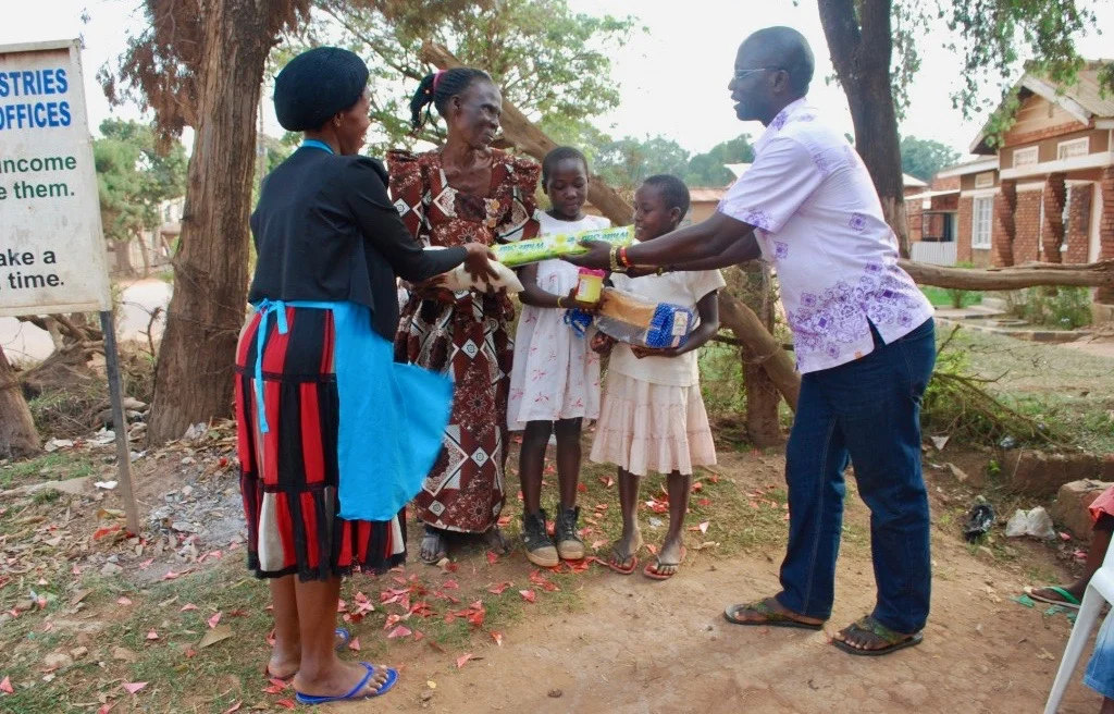 Hope for the future. Robina receives her first donation from TFCM.