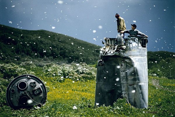  RUSSIA. Altai Territory. 2000. Villagers collecting scrap from a crashed spacecraft, surrounded by thousands of white butterflies.  Environmentalists fear for the region's future due to the toxic rocket fuel. 