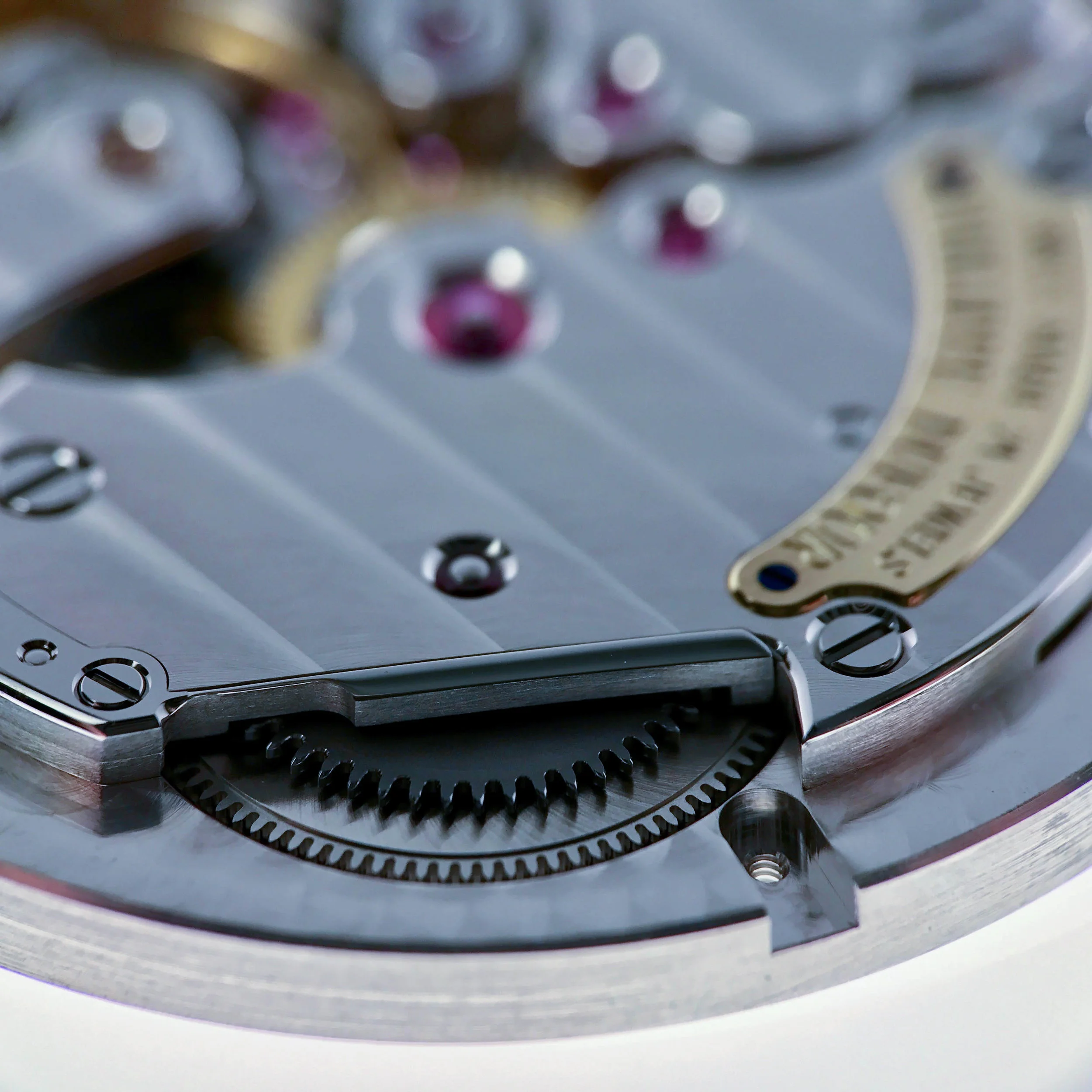 The finished click set on the barrel bridge. On the bridge meshing with the ratchet wheel above the barrel. The lower cut out will house the casing clamp securing the movement in the case.
