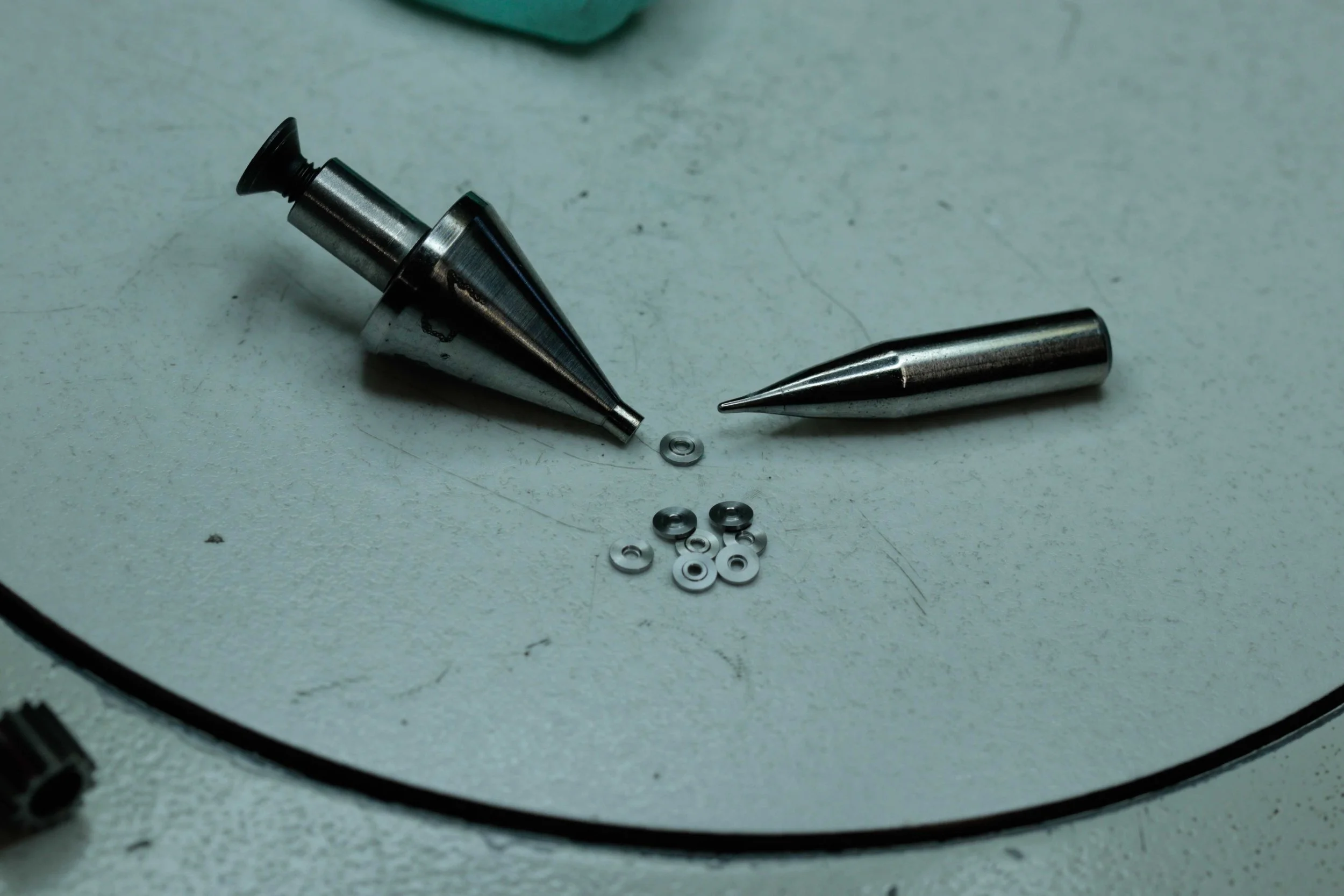 A simple jig used to hold a single blank at a time to be machined.