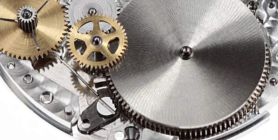 The small steel piece below the barrel is the click for the barrel ratchet wheel to manual release the power from the barrel once the automatic module is removed.