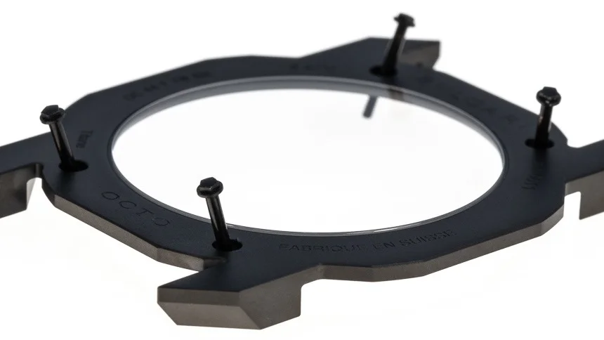 The 4 screws in place illustrating their length which travel through to the bezel.